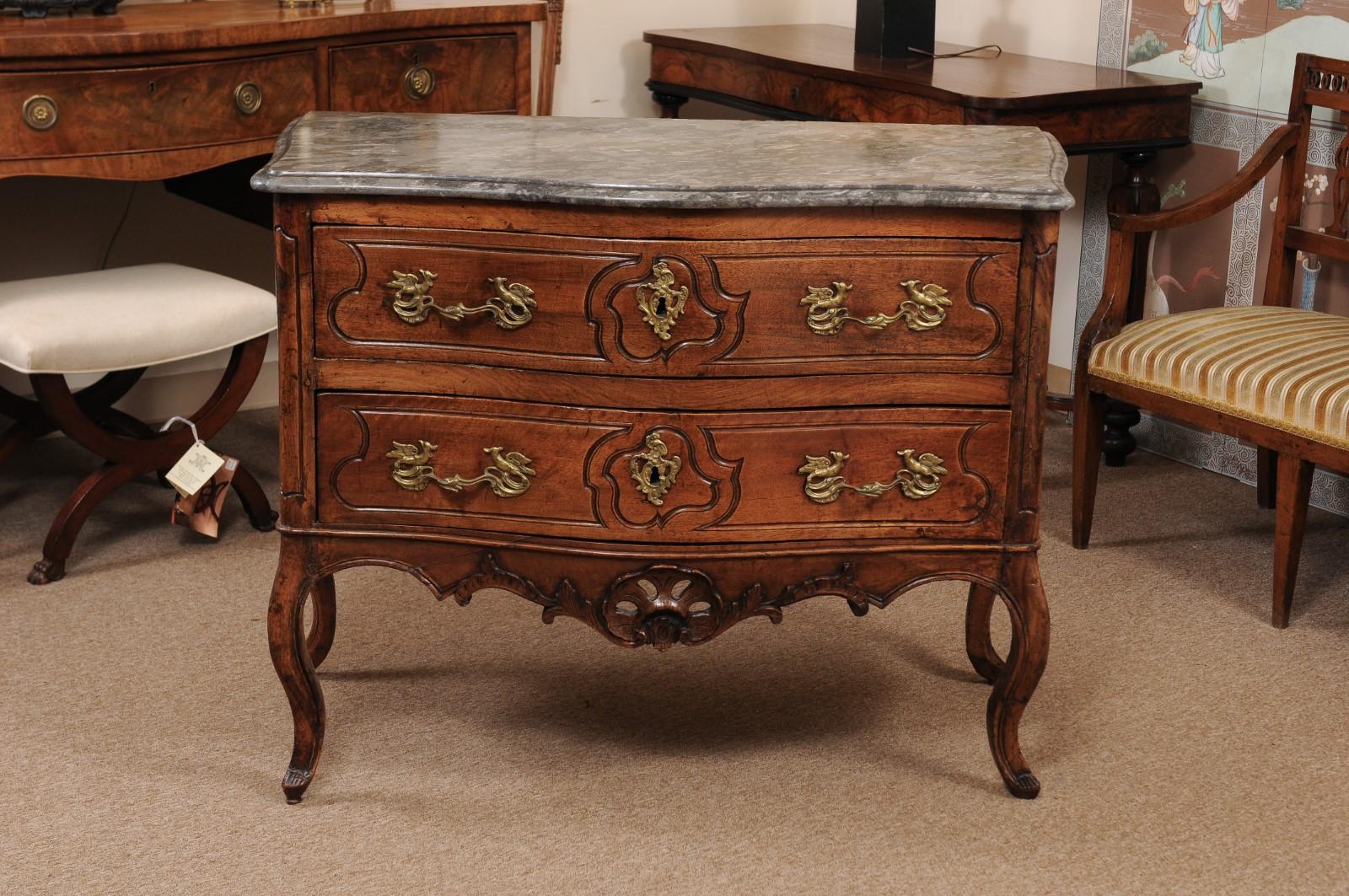 18th century French Louis XV walnut commode with grey marble top, pierced apron, & 2 drawers.
