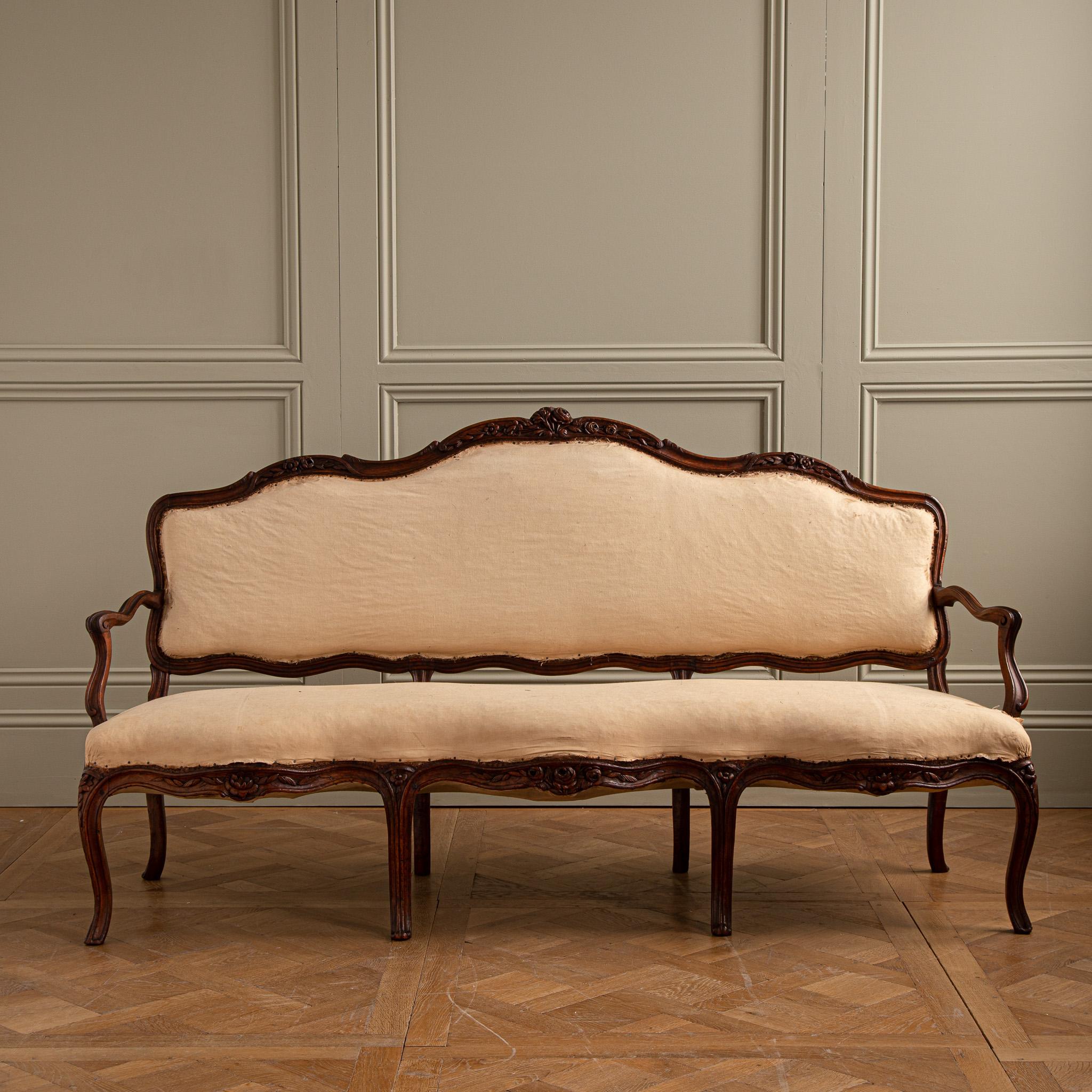 Sofa in Walnut,molded and sculpted backrest with triple convolution,recessed armrests,resting on eight arched serpentine legs.
of the Louis XV Period.
We can re cover the Sofa upon request.
We can source fabric or you can also supply your own.
