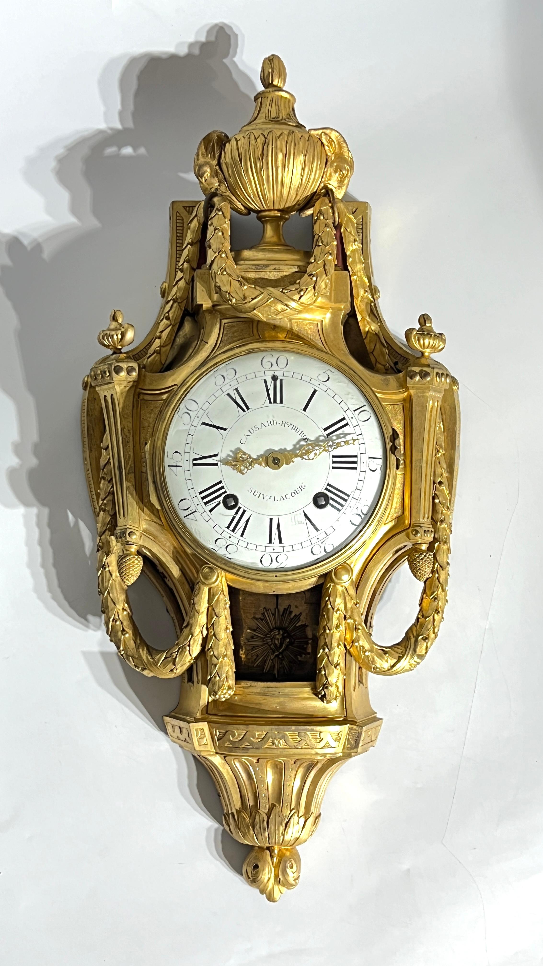 French Louis XV period ormolu bronze cartel clock by Edme-Jean Causard (1718-1780) measuring 28 by 13 by 5 inches, with original pendulum.  Dial signed Causard Hgr du Roy - Suivt Lacour.  

This baluster shaped clock in the manner of Jean-Charles