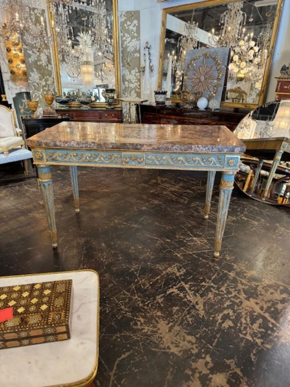 Truly exceptional 18th century Italian Louis XVI carved and giltwood console. Painted in a pretty turquoise blue with outstanding gold giltwood carvings.  Lovely marble top as well.  Stunning! Circa 1780.
61.5w x 30d x 38h
