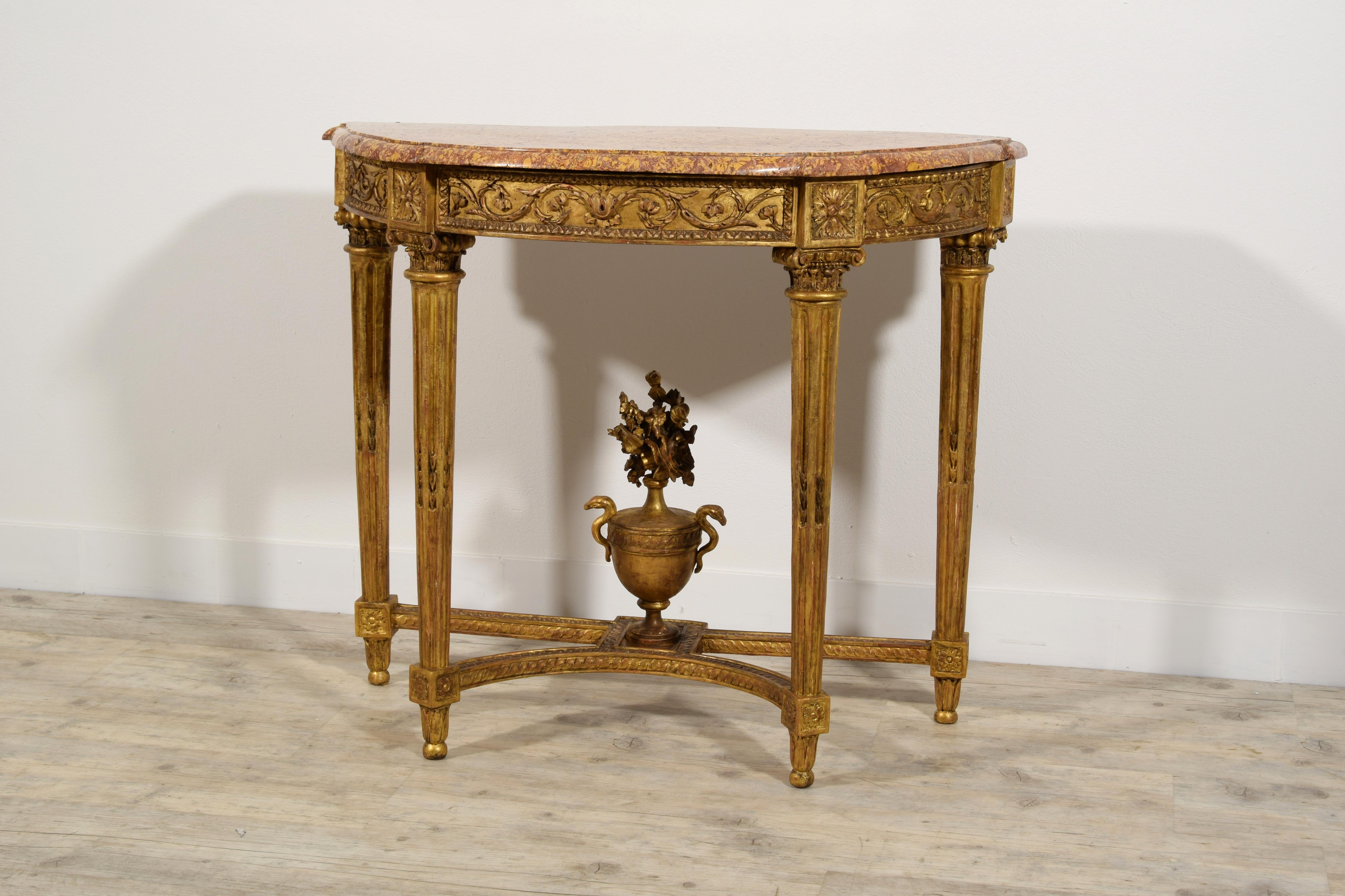 18th Century, French Louis XVI carved gilt wood console 

This elegant wooden console finely carved and golden, fully represents the taste that was established in France in the second half of the eighteenth century, in the Louis XVI era.
The