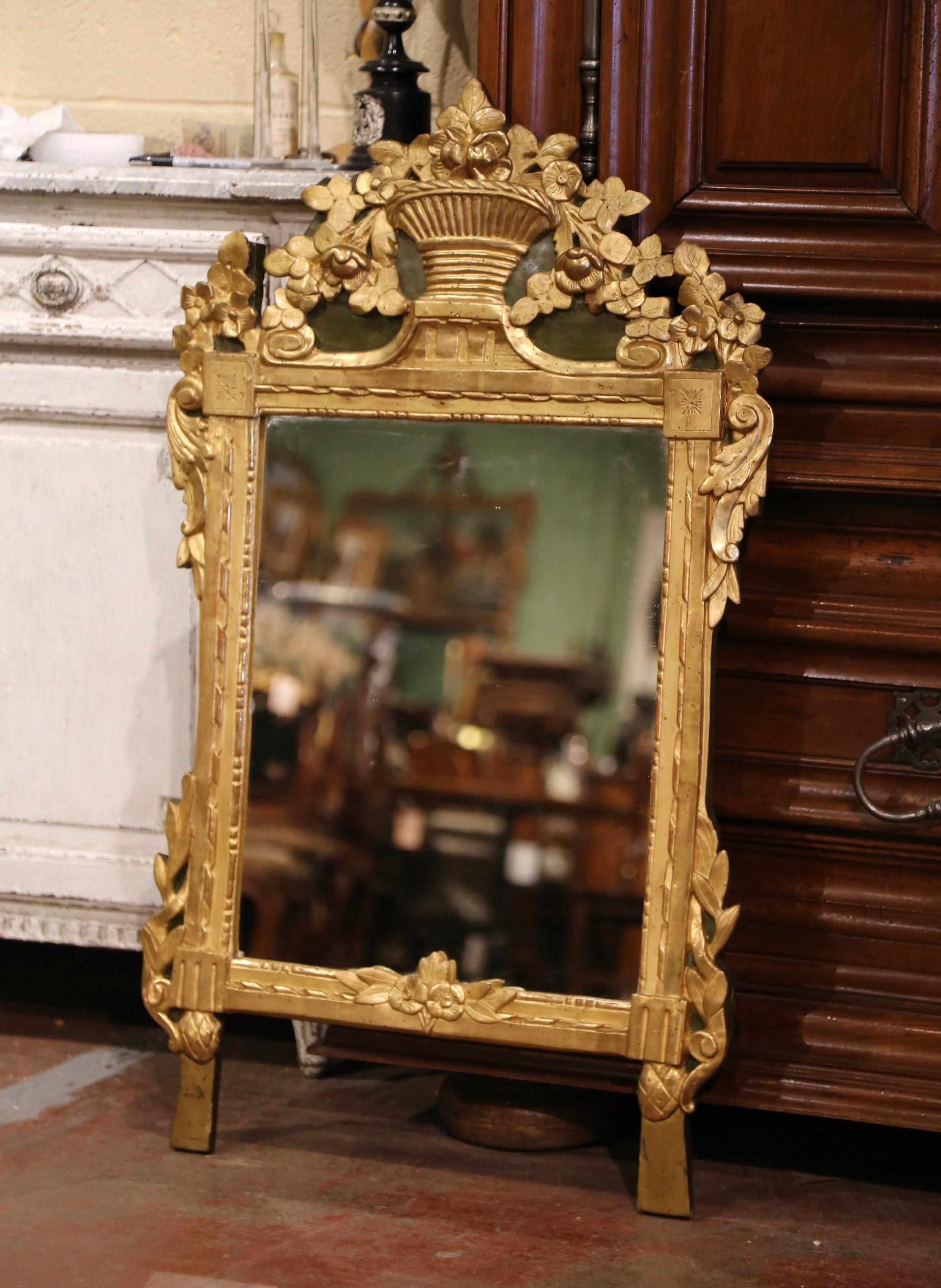 This elegant, antique gilt mirror would make a charming addition to an entryway or powder room. Crafted in Southern France, circa 1780, the rectangular mirror is heavily carved and exemplifies the design elements of the Rococo and Baroque style. The