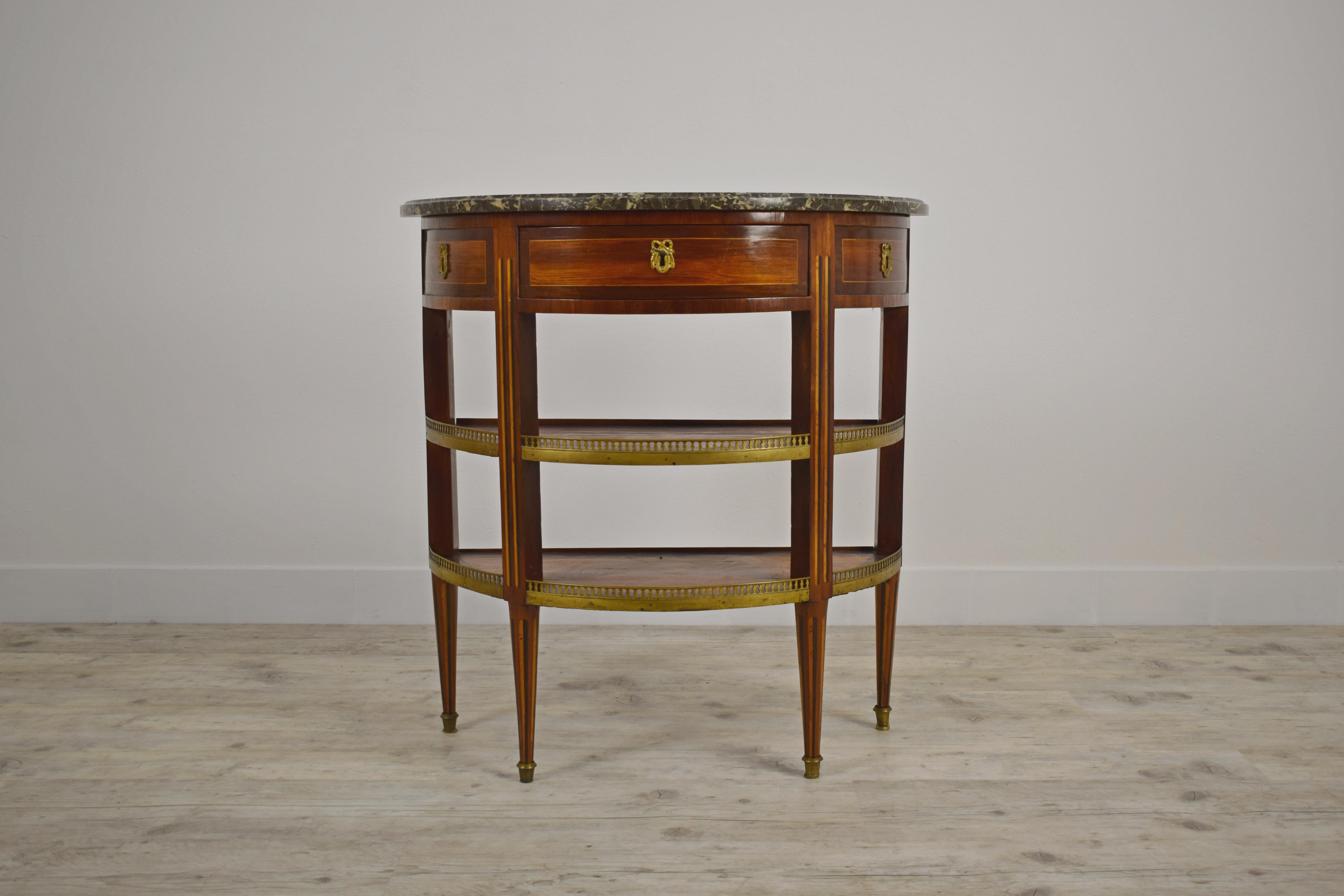 18th century French Louis XVI demilune wood dessert console with marble top

This small and elegant dessert console was made in France in the eighteenth century, in the Louis XVI period. It has a half-moon structure (demilune) in finely paved