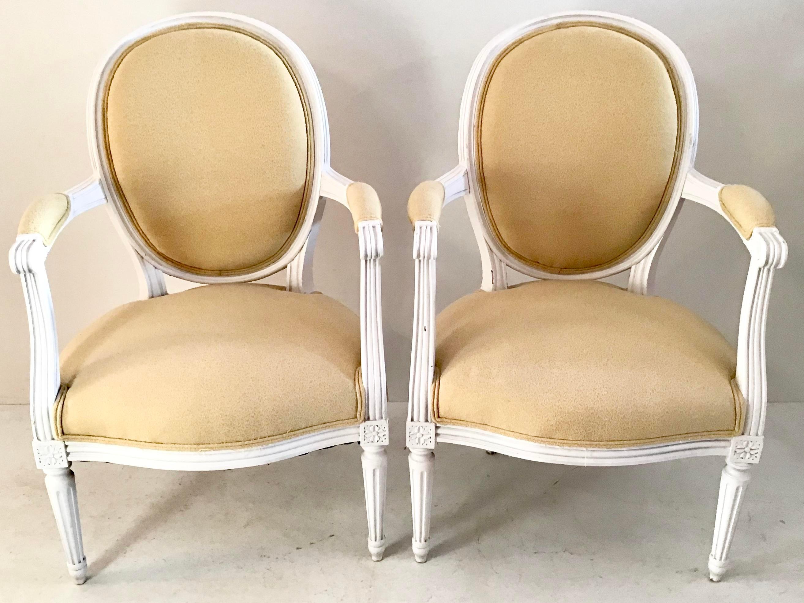 Pair of 18th century Louis XVI fauteuils with painted white frames and yellow upholstery. Some wear, but very nice conditions.