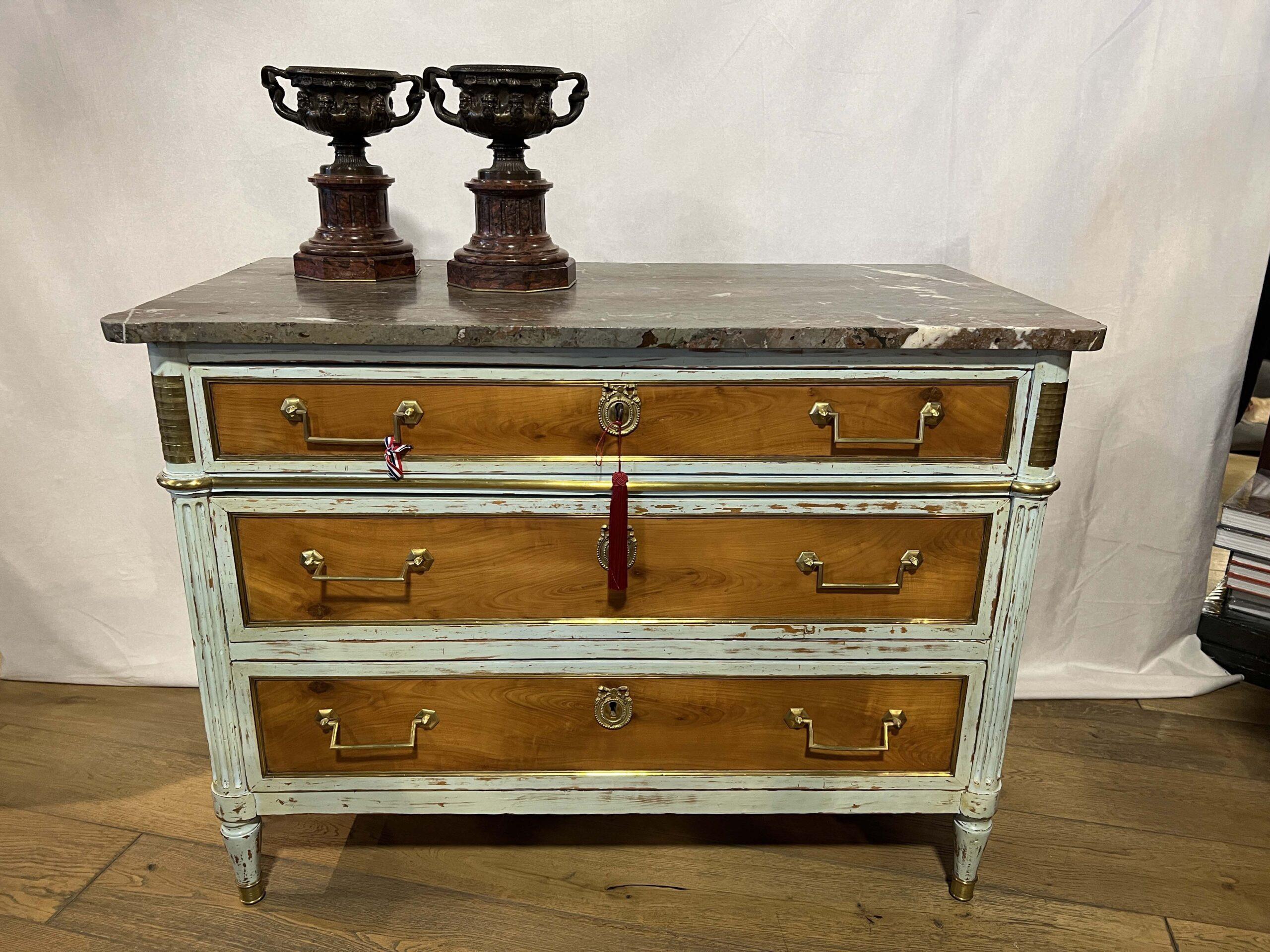 
18th Century French Louis XVI Fruitwood Chest with the ORIGINAL blue paint.  The Specimen Marble is beautiful and the Original Hardware is Stunning.  Pictured urns on top are not included.