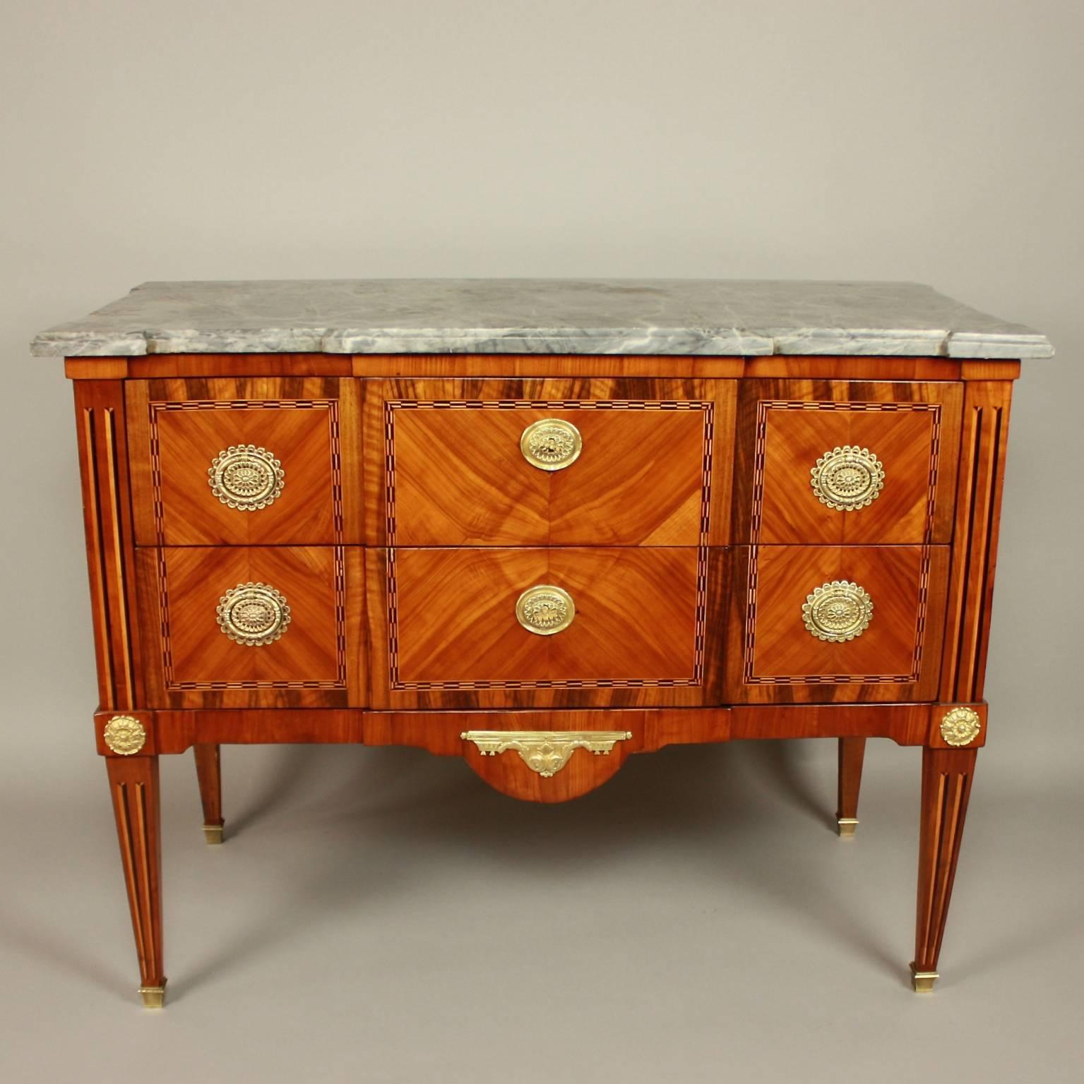 18th century French Louis XVI gilt-bronze mounted Geometrical Marquetry commode

A Louis XVI gilt-bronze mounted geometrical marquetry commode or chest of drawers with a shaped moulded mottled grey marble top above two long drawers of break-front