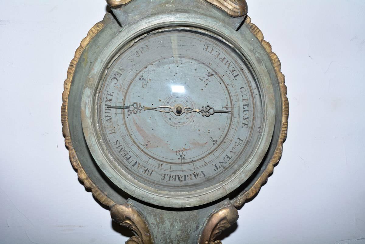A stunningly beautiful 18th century French gold gilt barometer is a weather instrument with mercury-filled glass thermometer still in working order. Wonderfully ornate, carved gilded wood frame with gold gilt and painted surface.