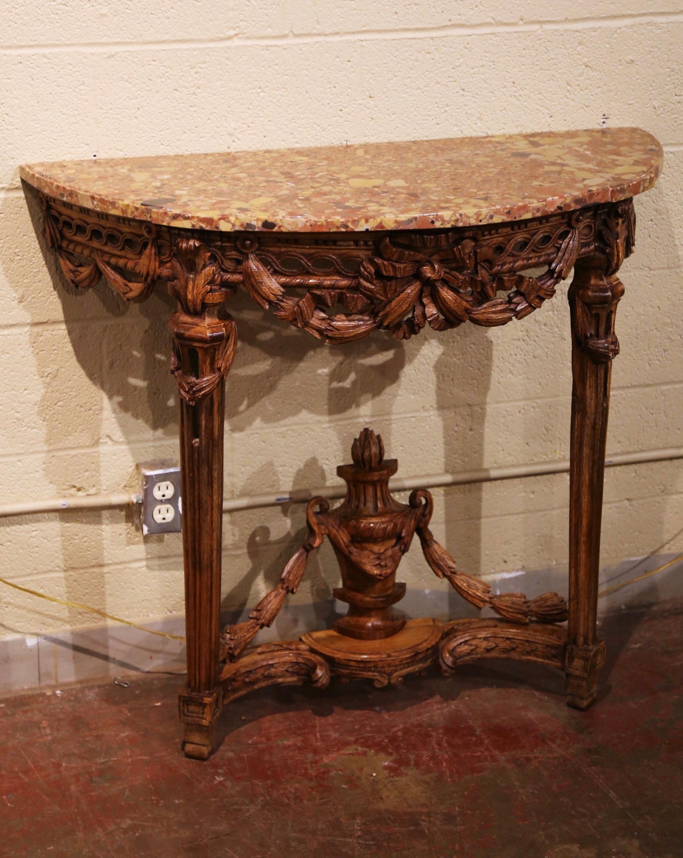 Decorate an entry or hallway with this elegant Louis XVI period demi-lune console table. Crafted in France circa 1780, and built of oak, the tall antique console shaped as a half moon, stands on fluted and tapered legs ending at the base with a