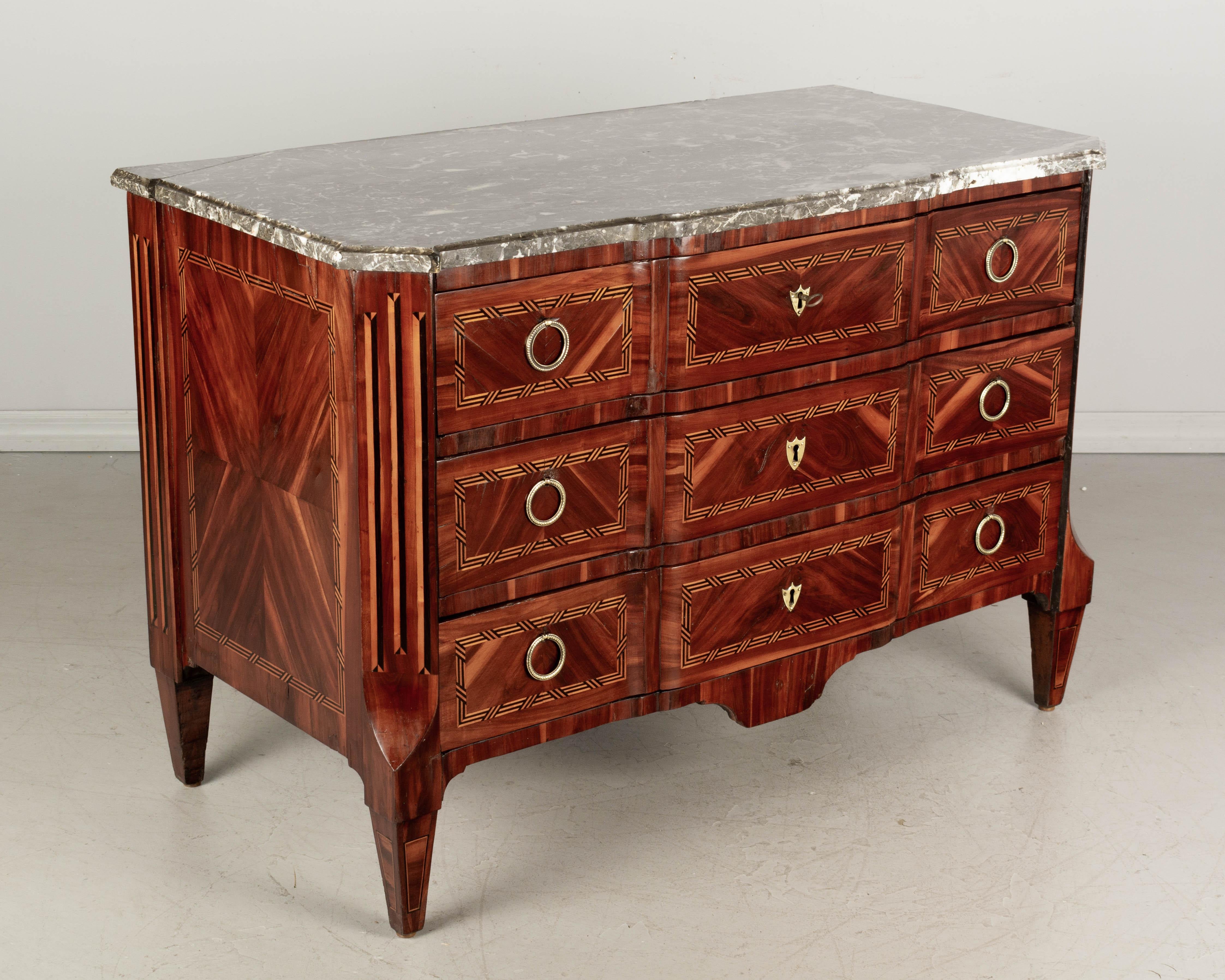 A fine 18th century French Louis XVI marquetry commode, or chest of drawers, with bookmatched and inlaid veneers of walnut, mahogany, cherry and ebony. Oak and pine as secondary woods. French polish finish with nice shiny luster. Three dovetailed