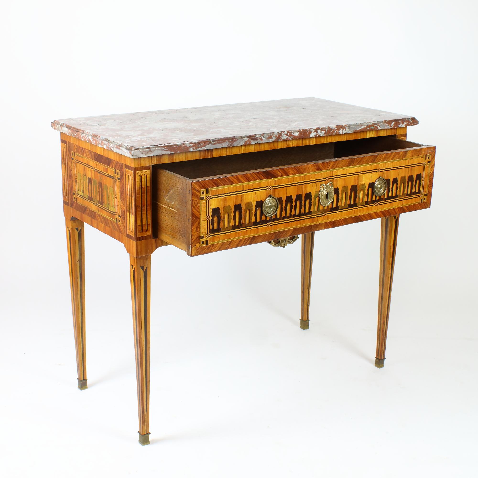18th century French Louis XVI neoclassical marquetry console table

A rectangular console table with one frieze drawer standing on four square, slender and tapering legs with trompe l'oeil fluting marquetry. The drawer as well as the sides