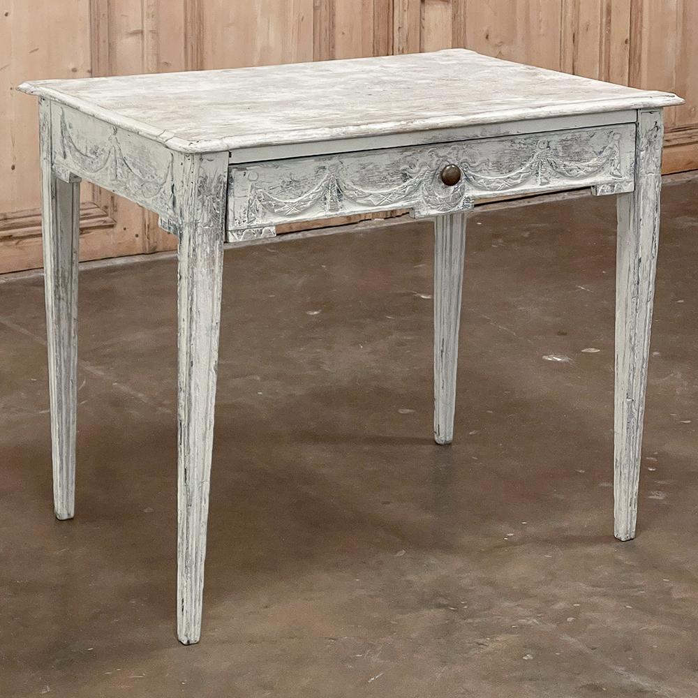 18th century French Louis XVI neoclassical painted end table is a classic example of talented rural artisans emulating the styles of the court. Louis XVI is known for reviving the classic architecture of ancient Greece and Rome, displayed here in