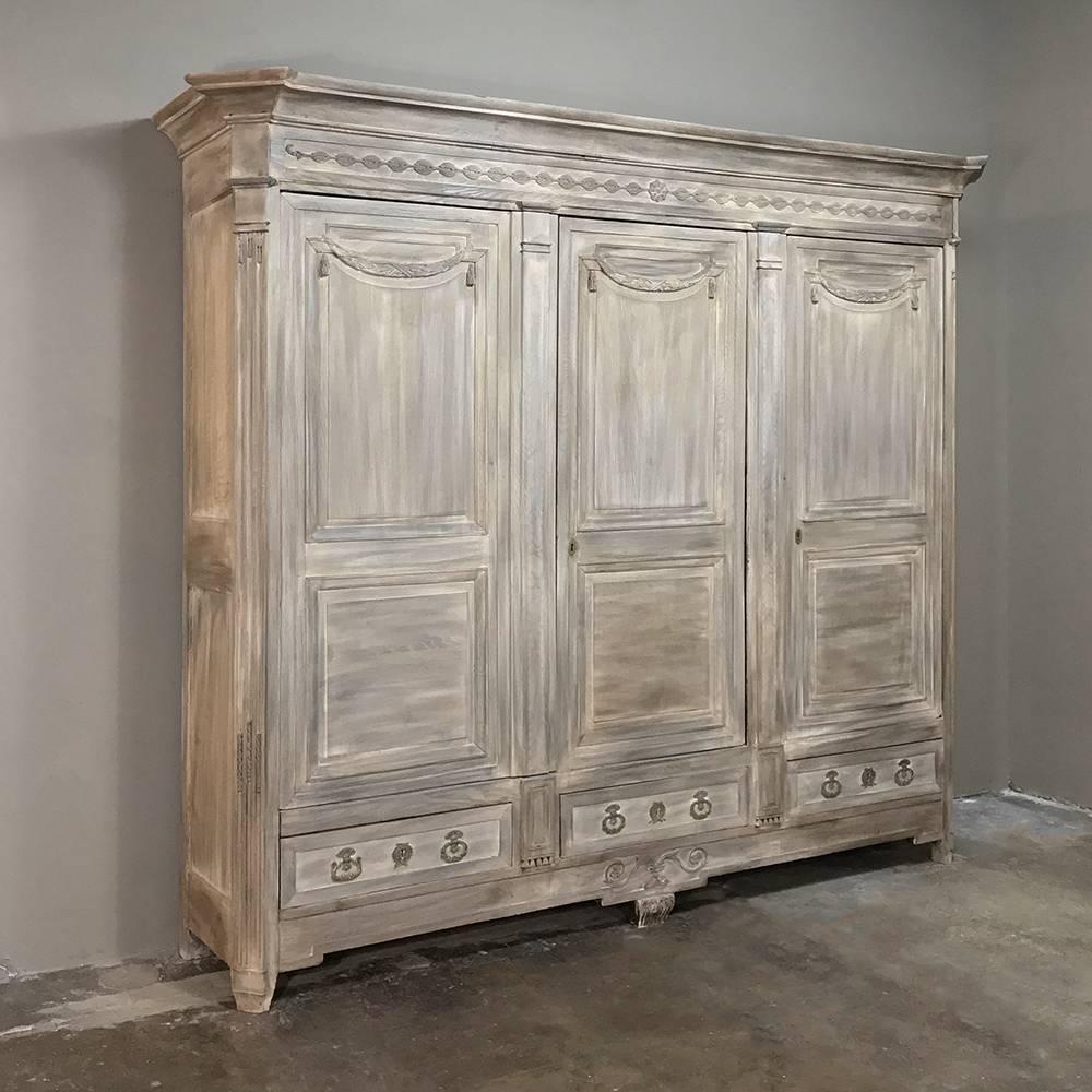 The stately presence of this 18th Century French Neoclassical Stripped Oak Armoire cannot be denied, with classical architecture inspired by ancient Greece & Rome as was so admired by Louis XVI. Completely hand-crafted from fine French old-growth