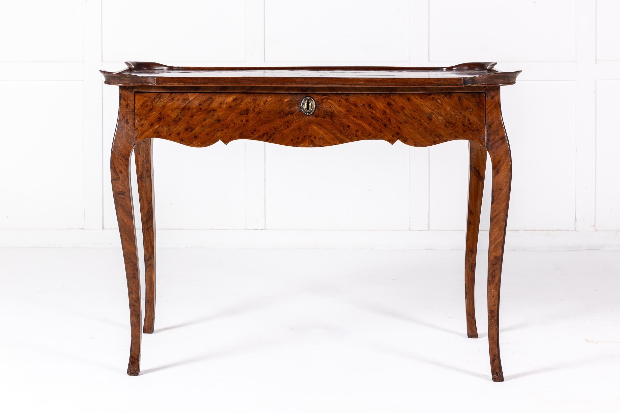 A Beautiful French Louis XVI Centre or Occasional Table in Burr Elm with Moulded Top.

This table is of delightful form with a shaped frieze and elegant cabriole legs. The top is shaped and moulded with four wells, one to each corner. The piece is