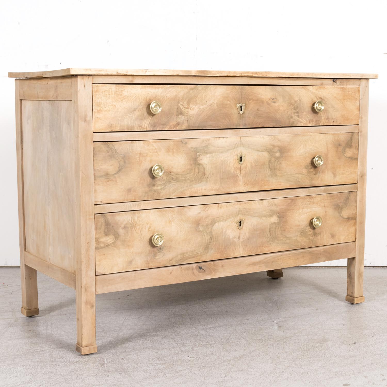 A striking mid-18th century French Louis XVI period commode handcrafted of walnut by talented artisans in Lyon, circa 1760s. Having a bookmatched burled walnut front, this handsome Lyonnaise chest of drawers has a bleached or washed finish and