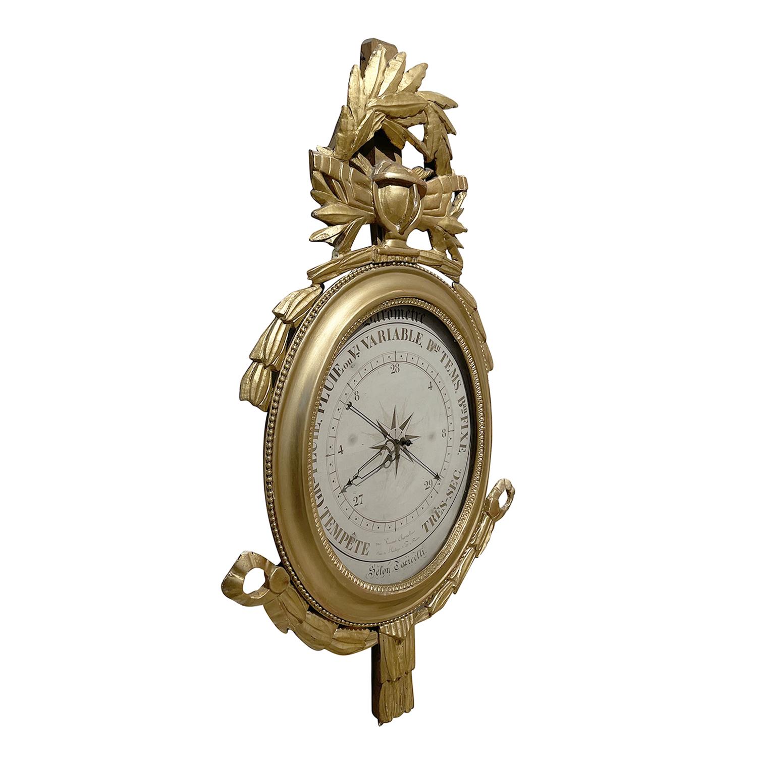 A gold, large antique French Louis XVI period barometer, signed by Torricelli in gilded wood and of oval shape with original scientific illustrations, in good condition. The detailed wall décor piece is consisting its original glass. Framed with
