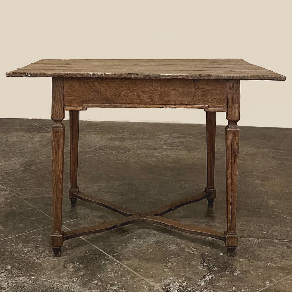 18th Century French Louis XVI Period Rustic Side Table is a dramatic example of the efforts of rural artisans to follow the dictates of the court.  The reign of Louis XVI ushered in a return to classical architecture in building and furniture