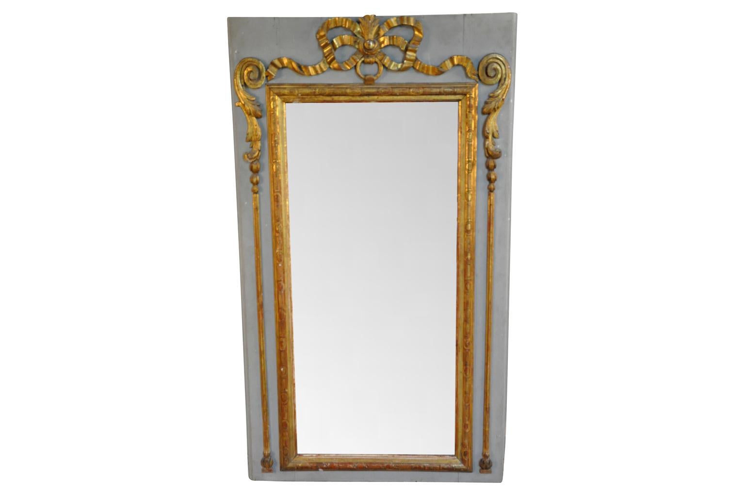 A very lovely later 18th century French Louis XVI period Trumeau mirror beautifully constructed from painted and gilt wood. The mirror retains its original mercury glass. Wonderful patina.