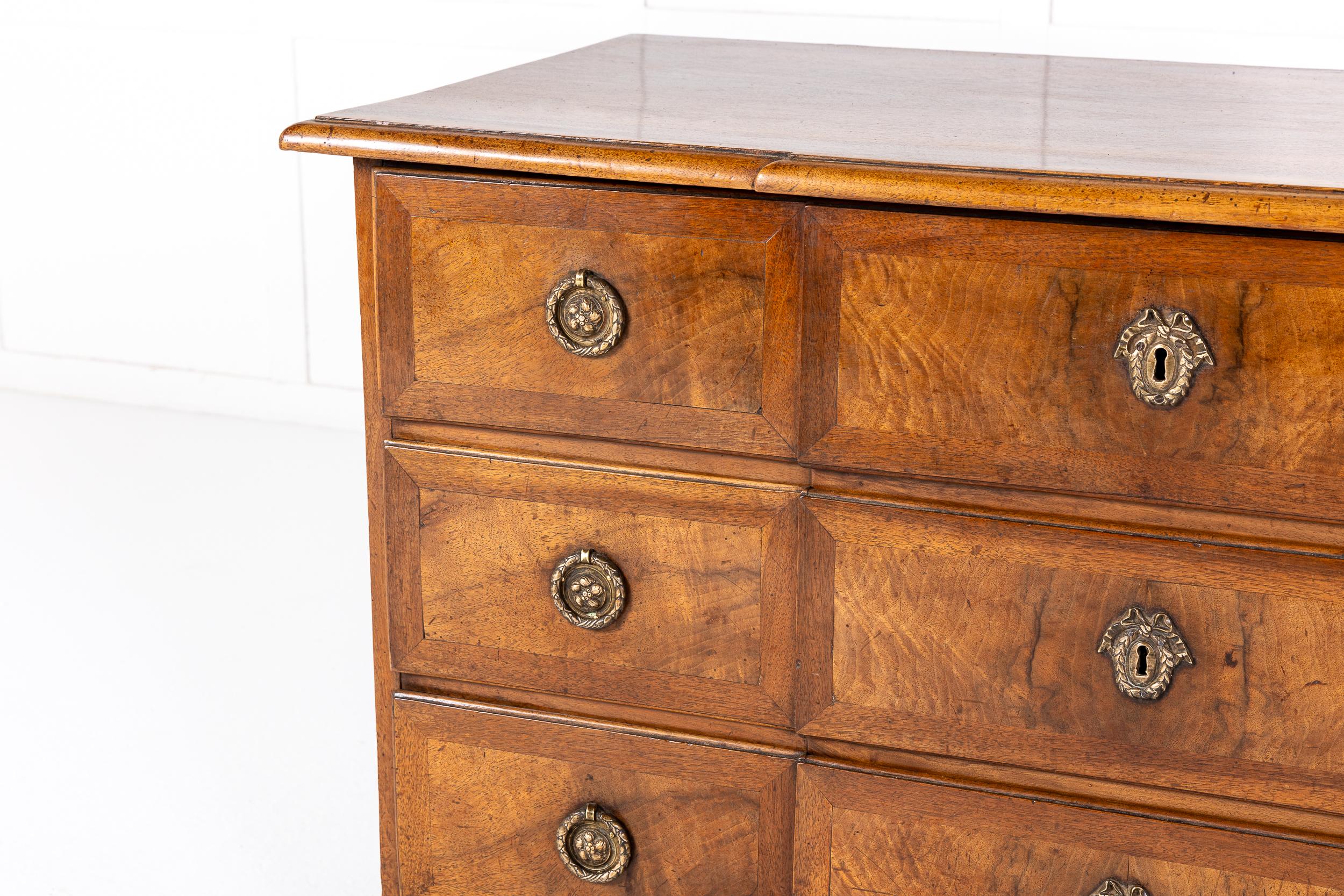 A Louis XVI Period French Walnut Commode of Excellent Colour.

This fine commode is of breakfront outline. Having three walnut crossbanded drawers with original metal handles and escutcheons. The commode has a frieze at the bottom of the breakfront