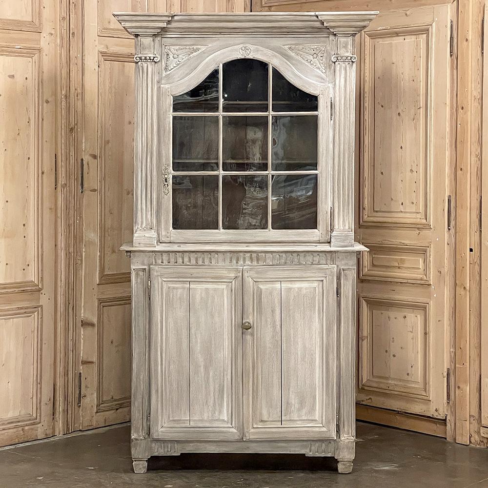 18th century French Louis XVI period whitewashed bookcase ~ vitrine in oak features a stately presence while retaining a rustic charm that is ideal for formal or casual decors alike! Boldly molded crown in the classical theme overlooks the arched