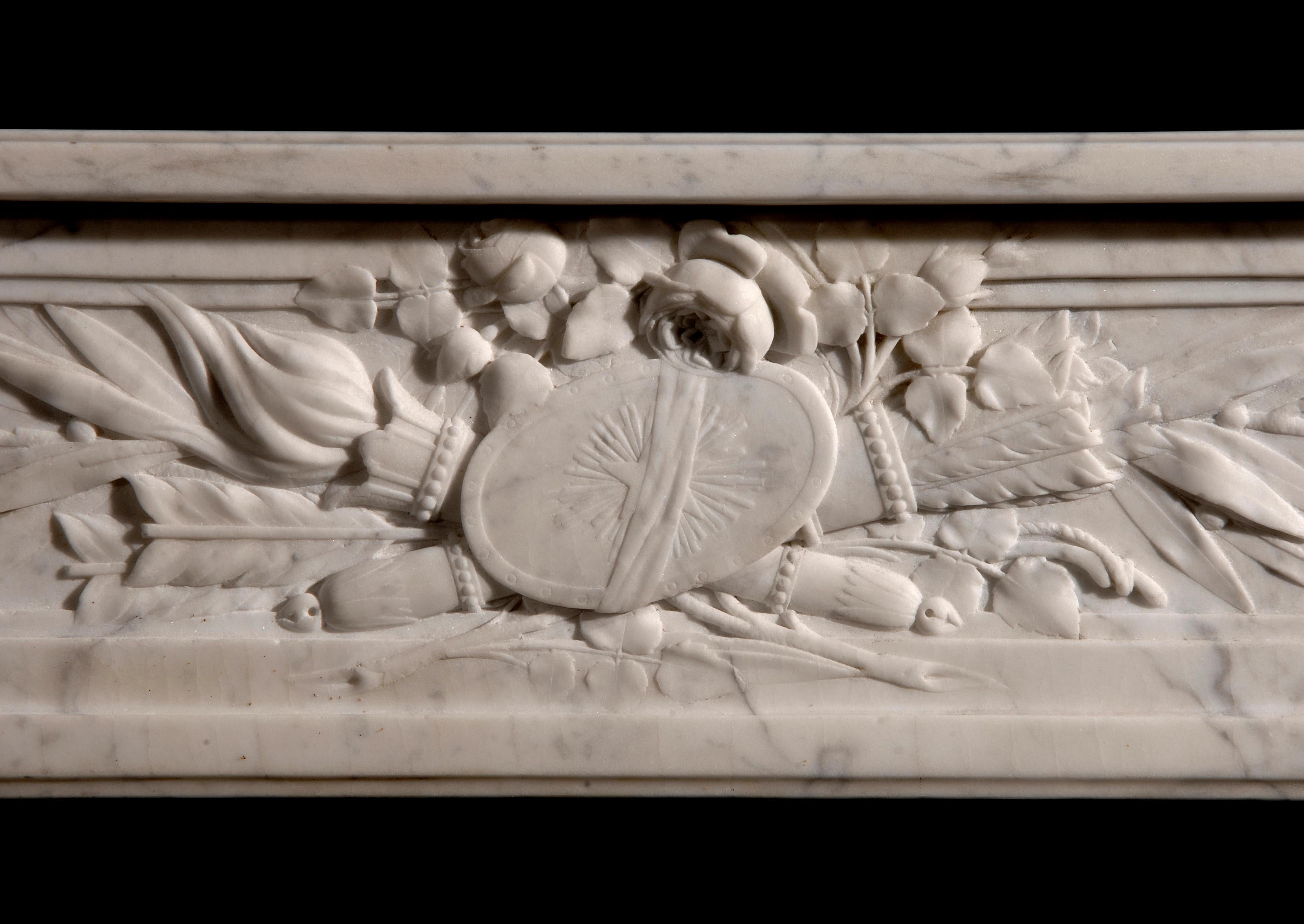 An 18th century French Louis XVI veined white marble fireplace, with quiver and leaf frieze, carved leaf drops to jambs, surmounted by pateras, circa 1770.

Measures: 
Shelf Width:	1835 mm      	72 1/4 in
Overall Height:	1175 mm      	46 1/4