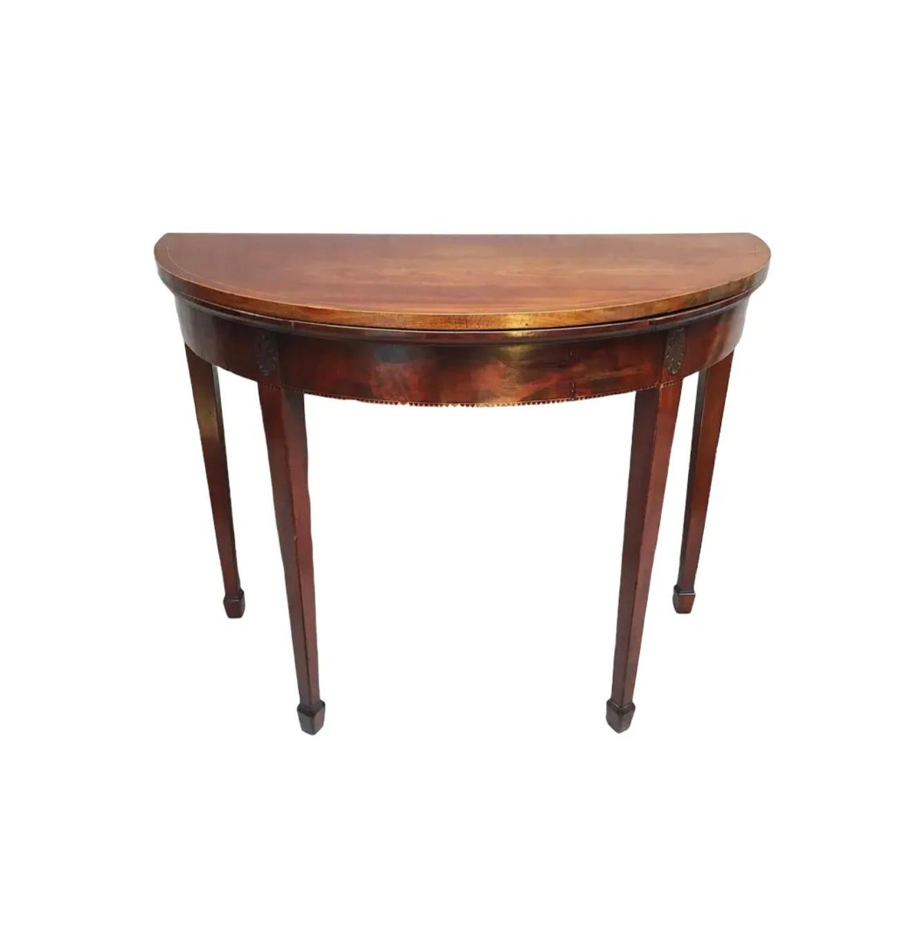 French folding round card table in mahogany. Box wood stringing inlay. Embossed leather insert when opened, circa 18th century.