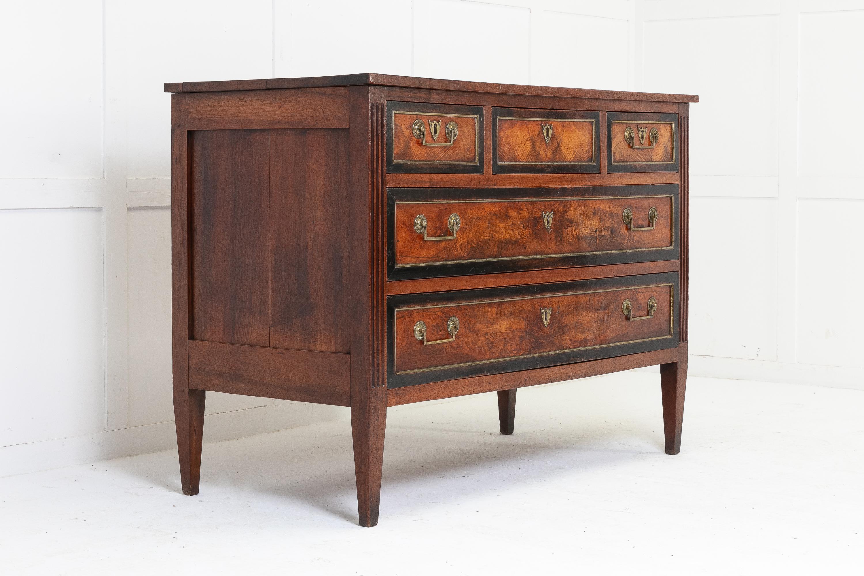 18th Century French mahogany commode retaining a beautiful rich colour. Having three small drawers over two long drawers, each drawer having ebonised banding and brass mouldings. Original drop bar handles and escutcheons. Standing on square tapering