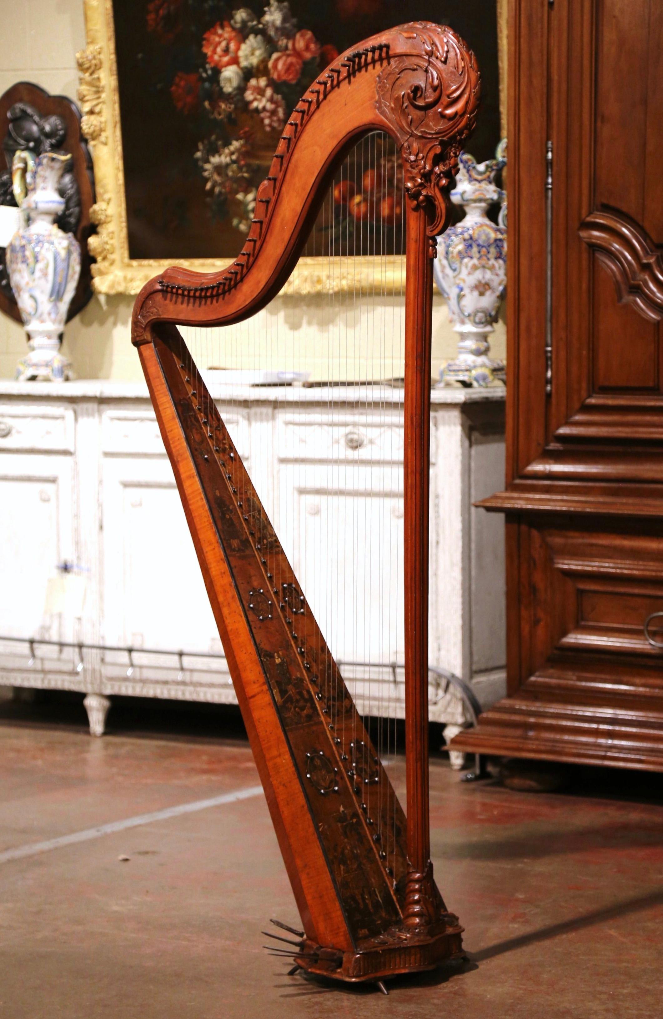 Decorate a living room with this elegant antique pedal harp. Crafted in France circa 1780, the single action musical instrument features 36 recently replaced strings to the gilt foliate faux rosewood sound board. The grained soundboard is further