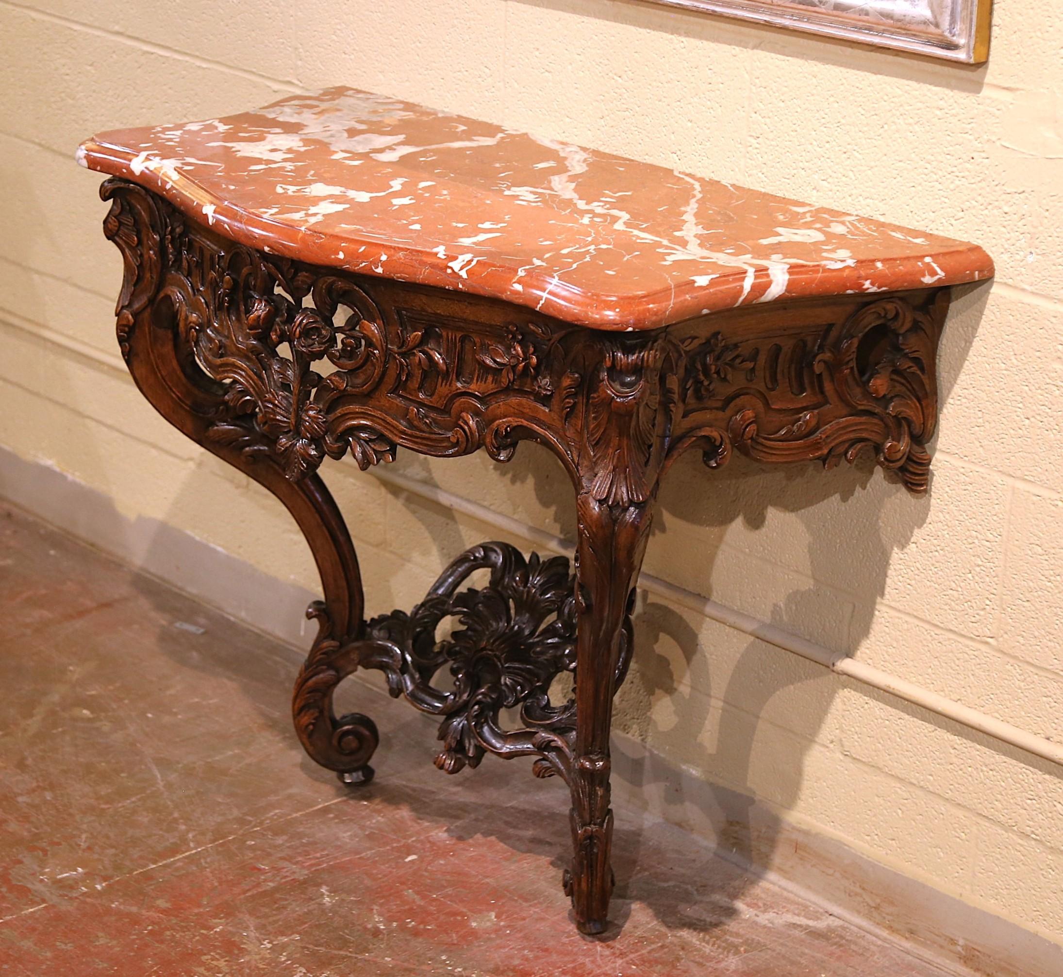 Dress an entry with this exceptional antique console. Crafted in Provence, France circa 1770, the table stands on elegant cabriole legs decorated with hand carved acanthus leaf at the shoulders, and ending with scrolled feet over leaves; the legs