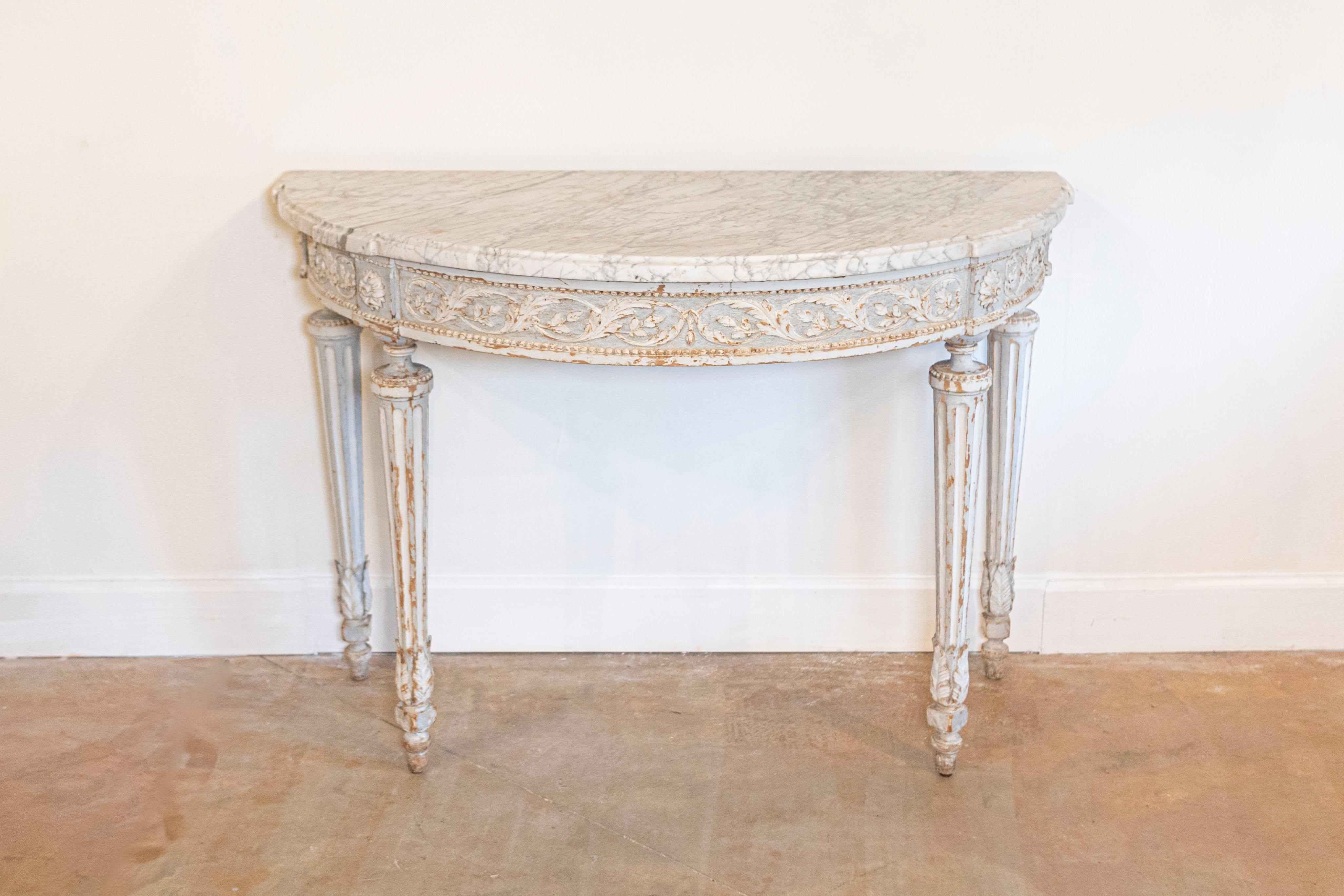 This elegant 18th-century French marble console table exemplifies the refined craftsmanship of the Louis XVI period. The demi-lune (half-moon) shape, a hallmark of neoclassical design, provides a graceful and understated silhouette. The table is