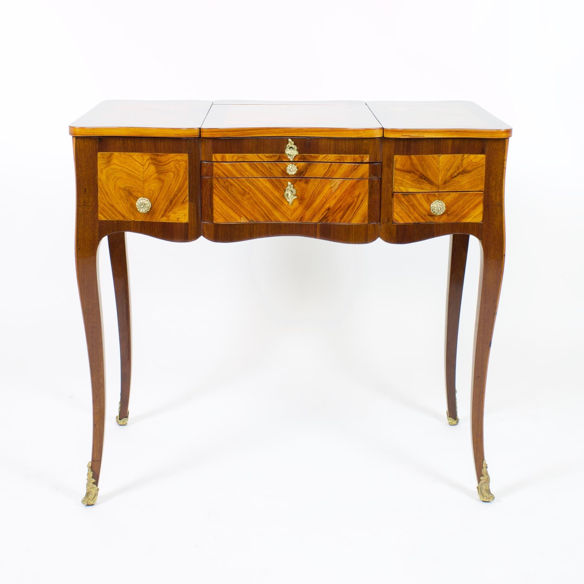18th century French Louis XV marquetry dressing table or so-called Coiffeuse

18th century Louis XV vanity dressing table or coiffeuse standing on four slender tapering cabriole legs, all sides and top decorated with elaborate mirrored parquetry.