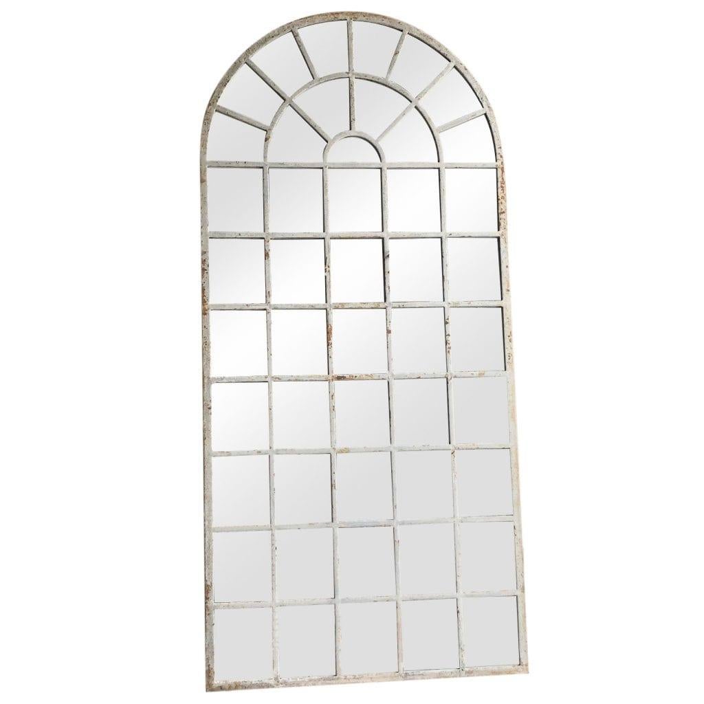 Late 18th Century, a very tall, antique Orangerie wall mirror with an arched top, in good condition. The structure has a cast iron antique frame and newly inserted mirrored panels. The antique wall décor represents the Renaissance Revival time