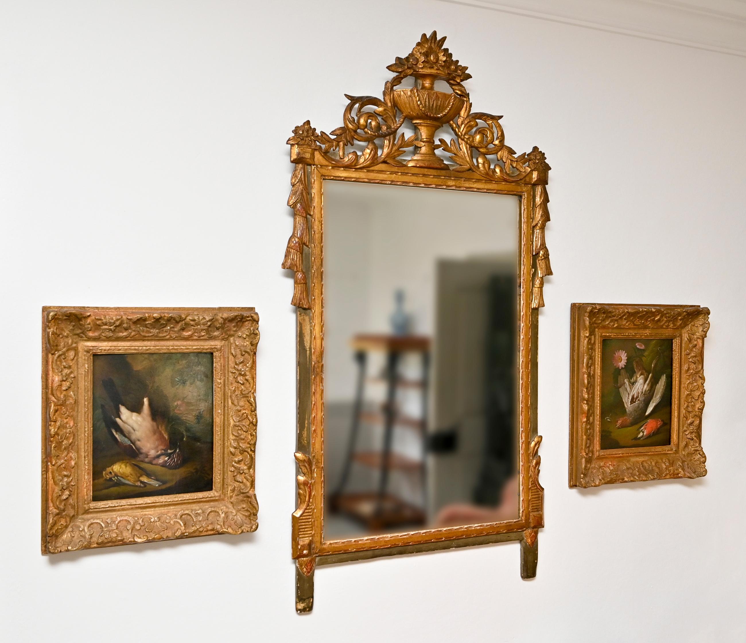 18th century French mirror Louis Seize Gilded wood carved original mirror glass
This delicate and beautiful mirror once embellished a noble house in France. The hand carved wooden frame with its original gilded and light grey colored surface nicely