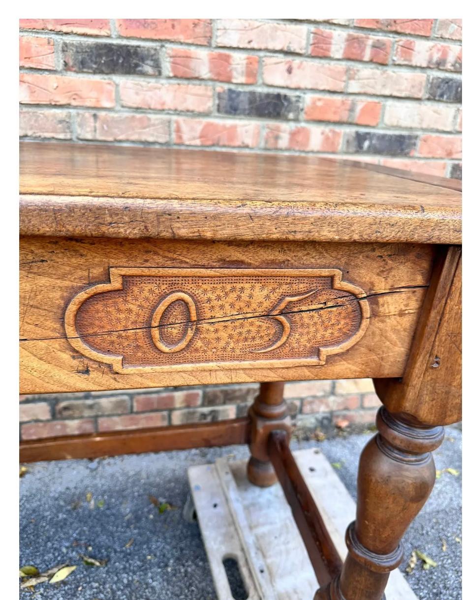 This is an absolutely stunning French monastery table. This table dates to 1705 as is evident by the hand carved numbers on the front. This piece wears its age beautifully with every inch of this piece having lovely patina. The top is made from a