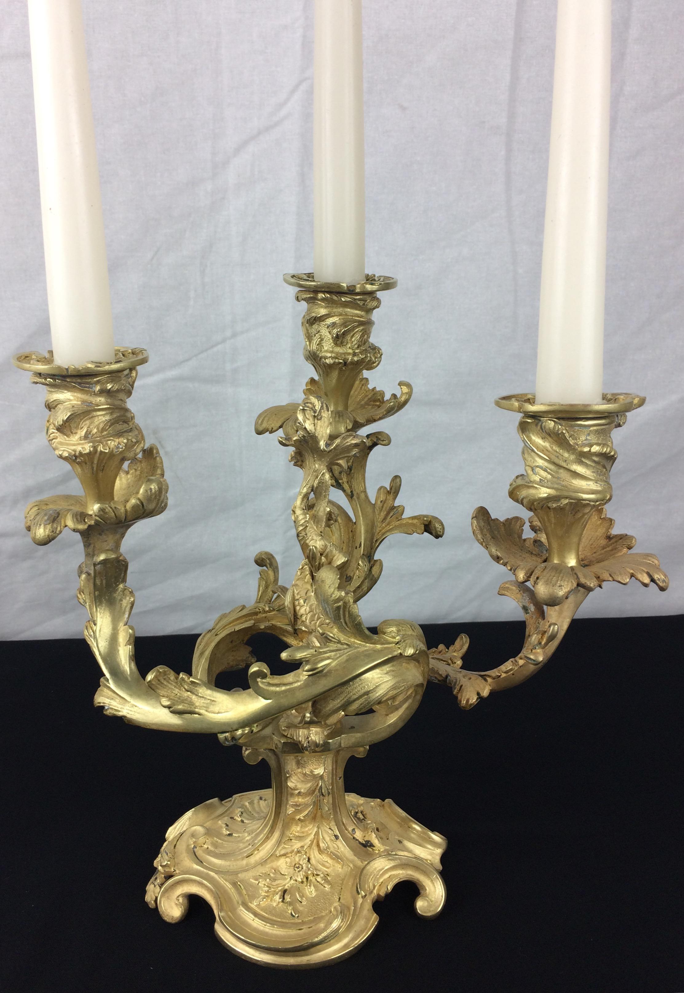 A very fine quality pair of 19th Century French Bronze Candelabras in the Napoleon III Style.  Original gilding on these beautiful bronze rocaille or rococo candelabras. 

The typical Napoleon III details are captivating, see detailed photos.
