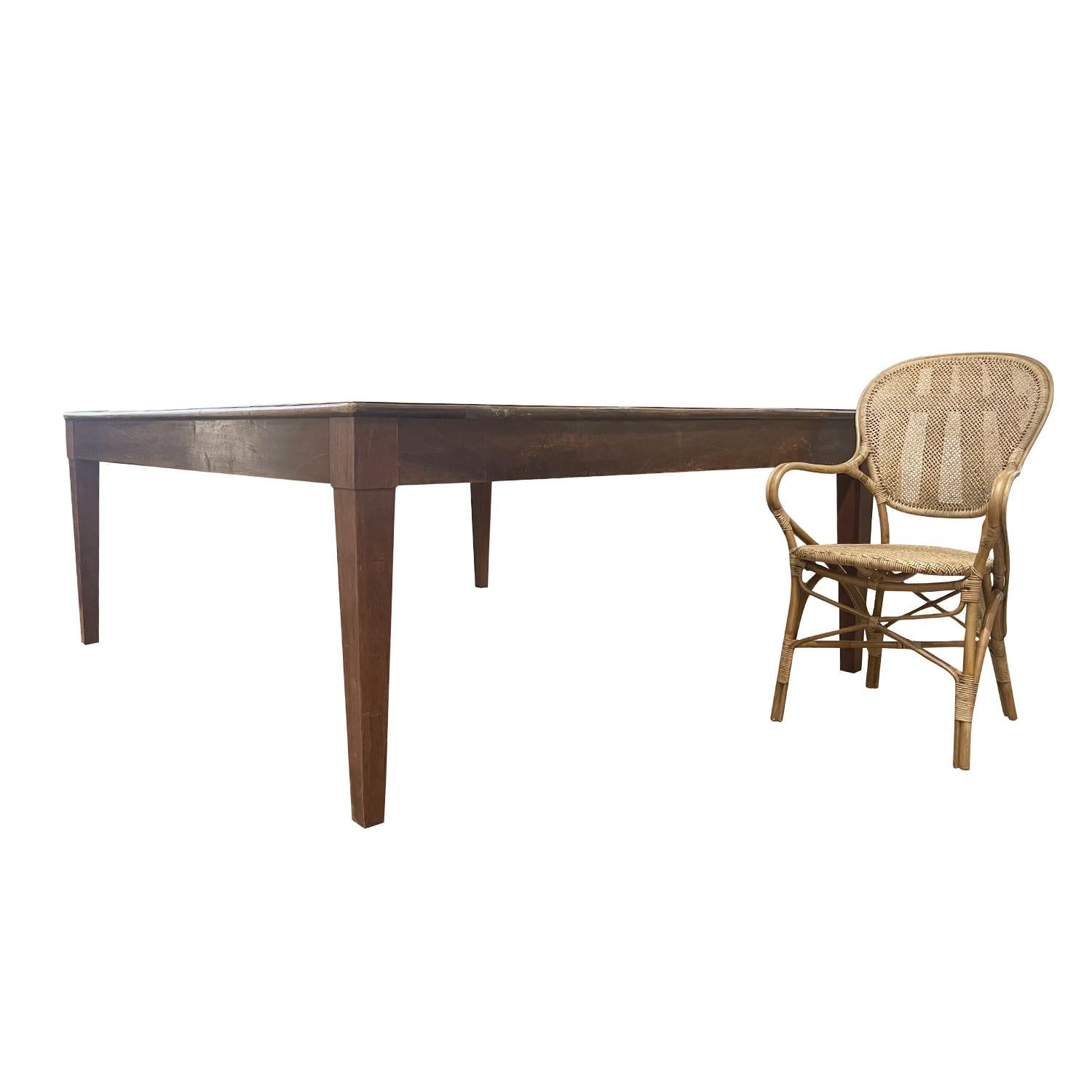An antique massive rectangular dining room table made of hand crafted Walnut, in good condition. This French Provincial farmhouse table has a strong and sturdy construction. Neo-Classical Style, wide planked hand waxed table top supported by