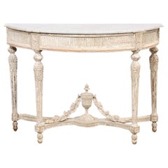 Console néoclassique française du XVIIIe siècle à plateau en marbre avec fleuron en forme d'urne sur la face inférieure