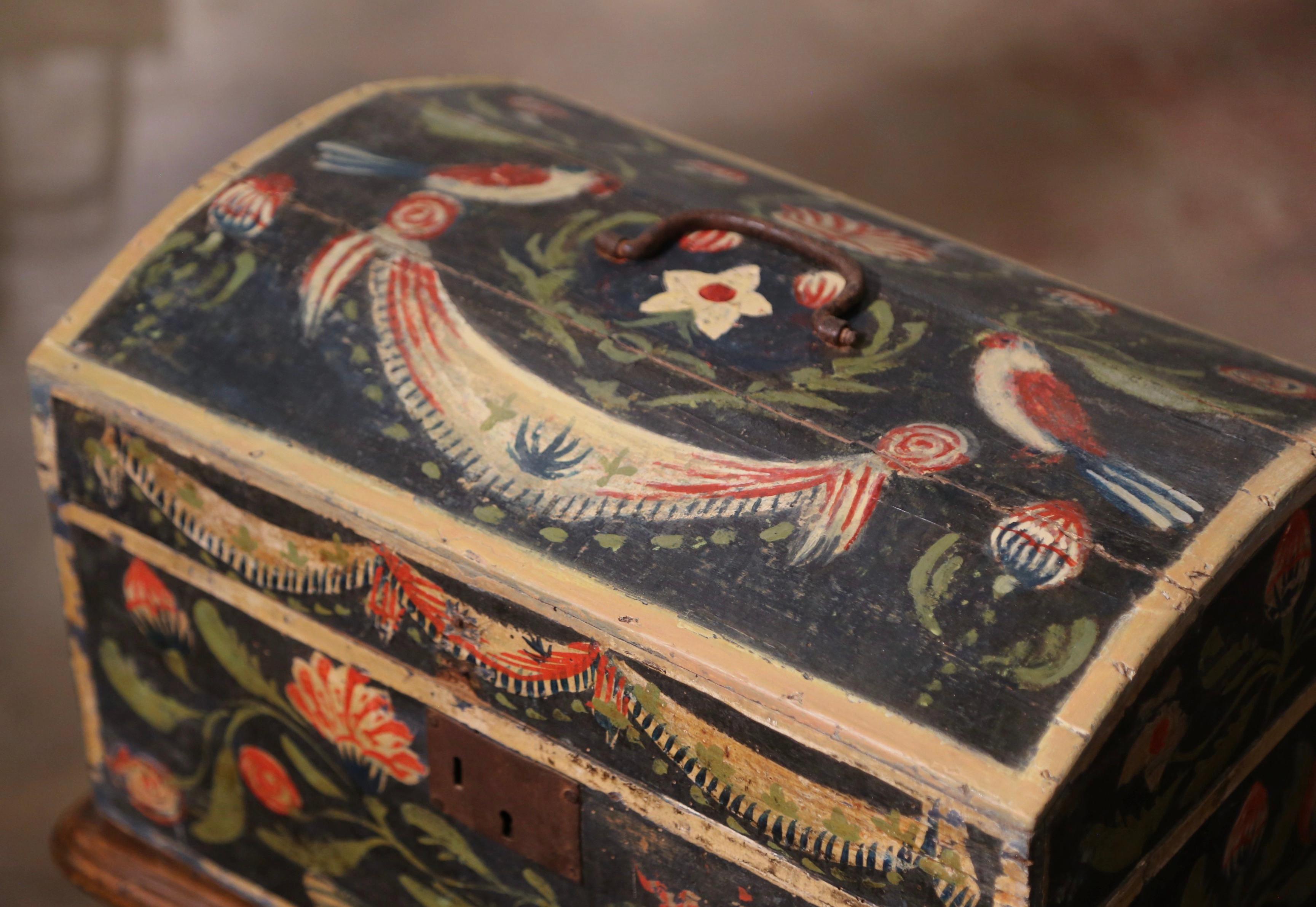 This beautifully executed antique wedding trunk was crafted in Normandy France, circa 1780. The colorful box with arched top, is embellished with the original iron lock plate and top handle; the cabinet is decorated with hand painted birds, swag,