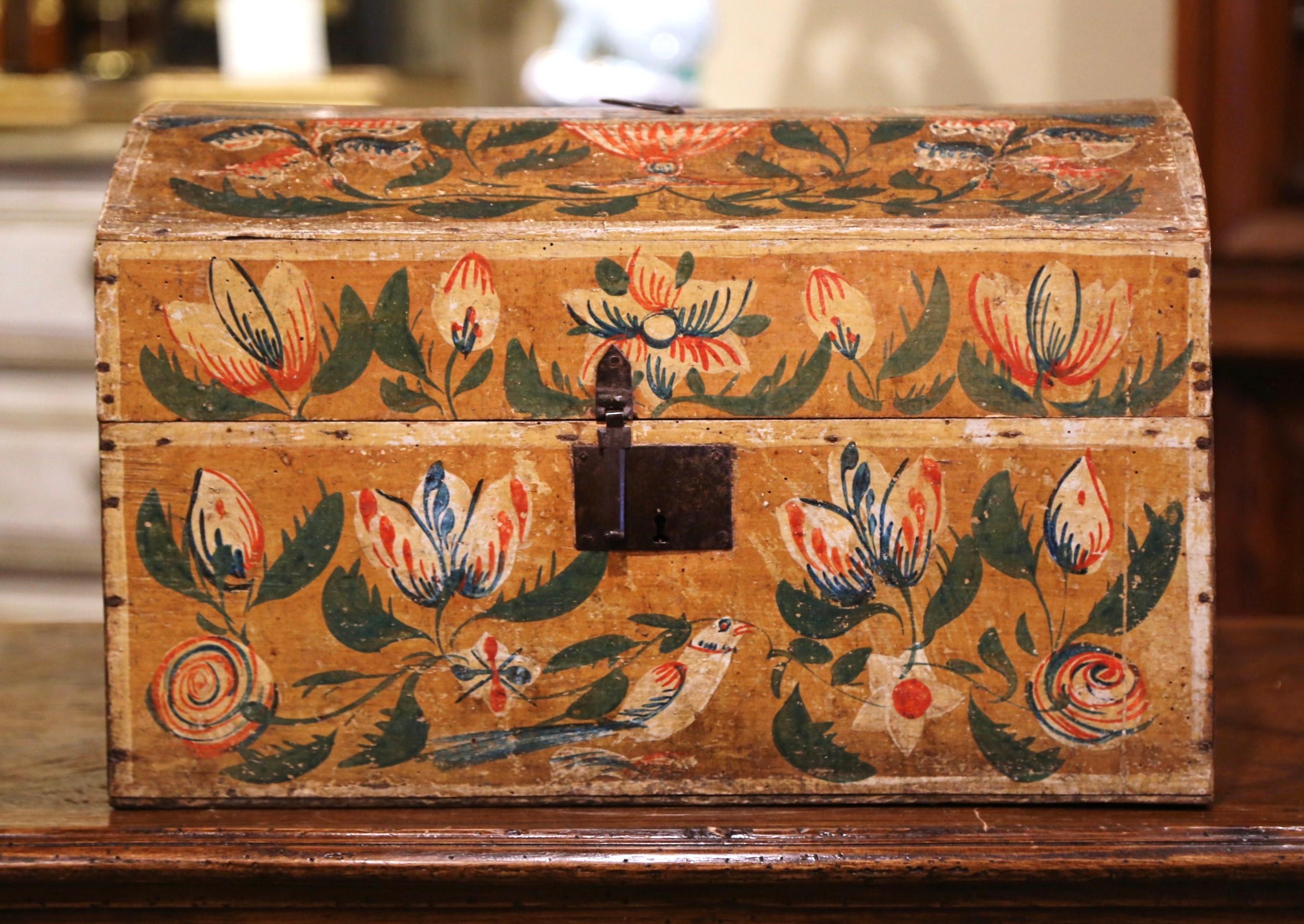 This beautifully executed antique wedding trunk was crafted in Normandy France, circa 1780. The colorful, arched box is decorated with multiple hand painted birds, flowers and leaves scattered on all four sides including on the bombe top; the small