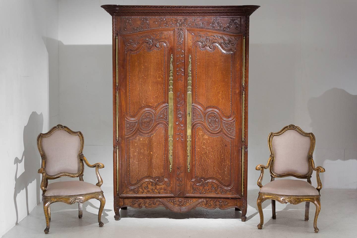 Excellent quality, very nice model, 18th century wonderfully carved French oak armoire with fantastic original brass metalwork and three massive door hinges each side.

       