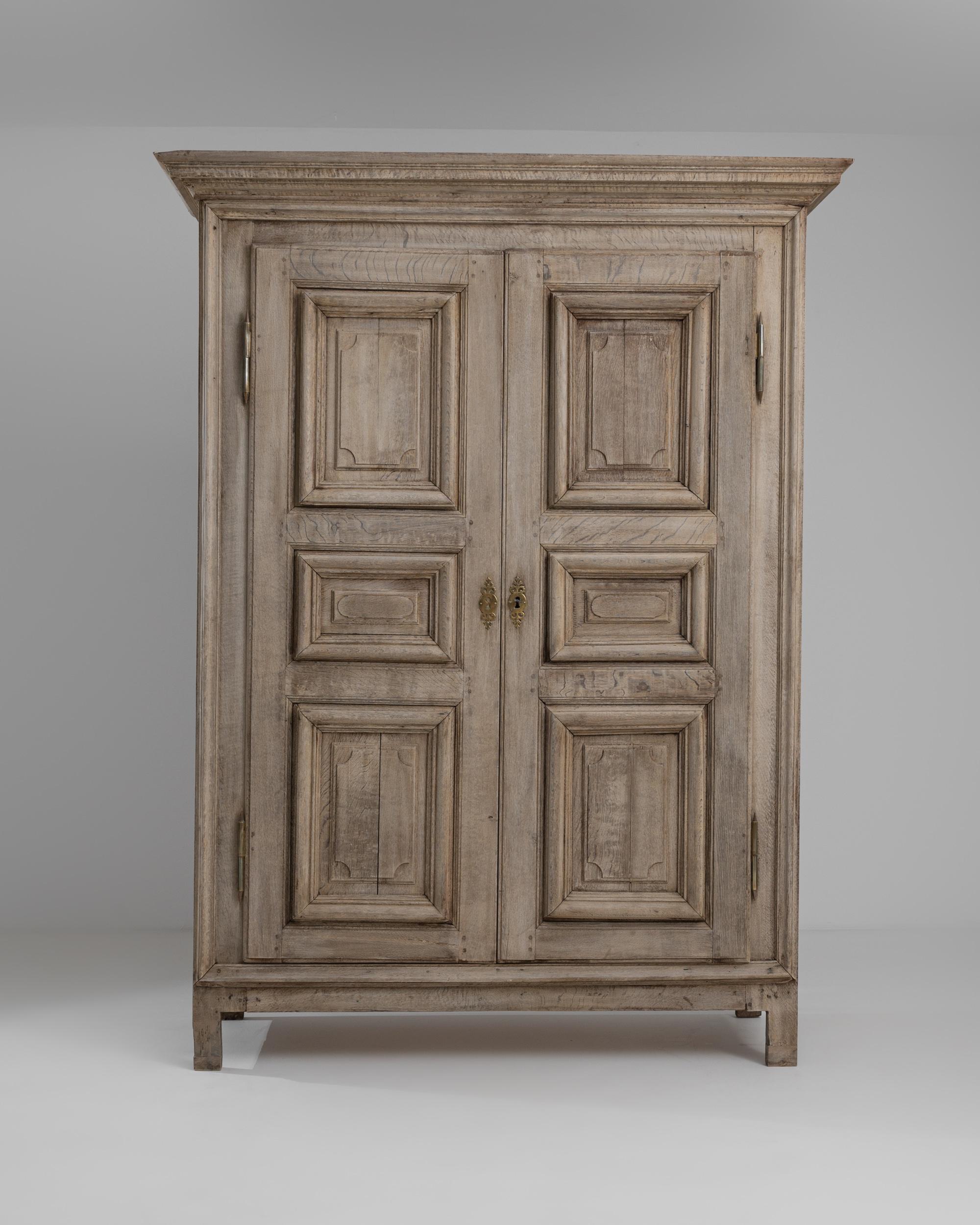 This handsome provincial armoire in natural oak makes a covetable find. Made in France in the 1700s, the bright, sunny tone of the carefully restored wood gives the cabinet a youthful character despite its years. Paneled doors open onto interior