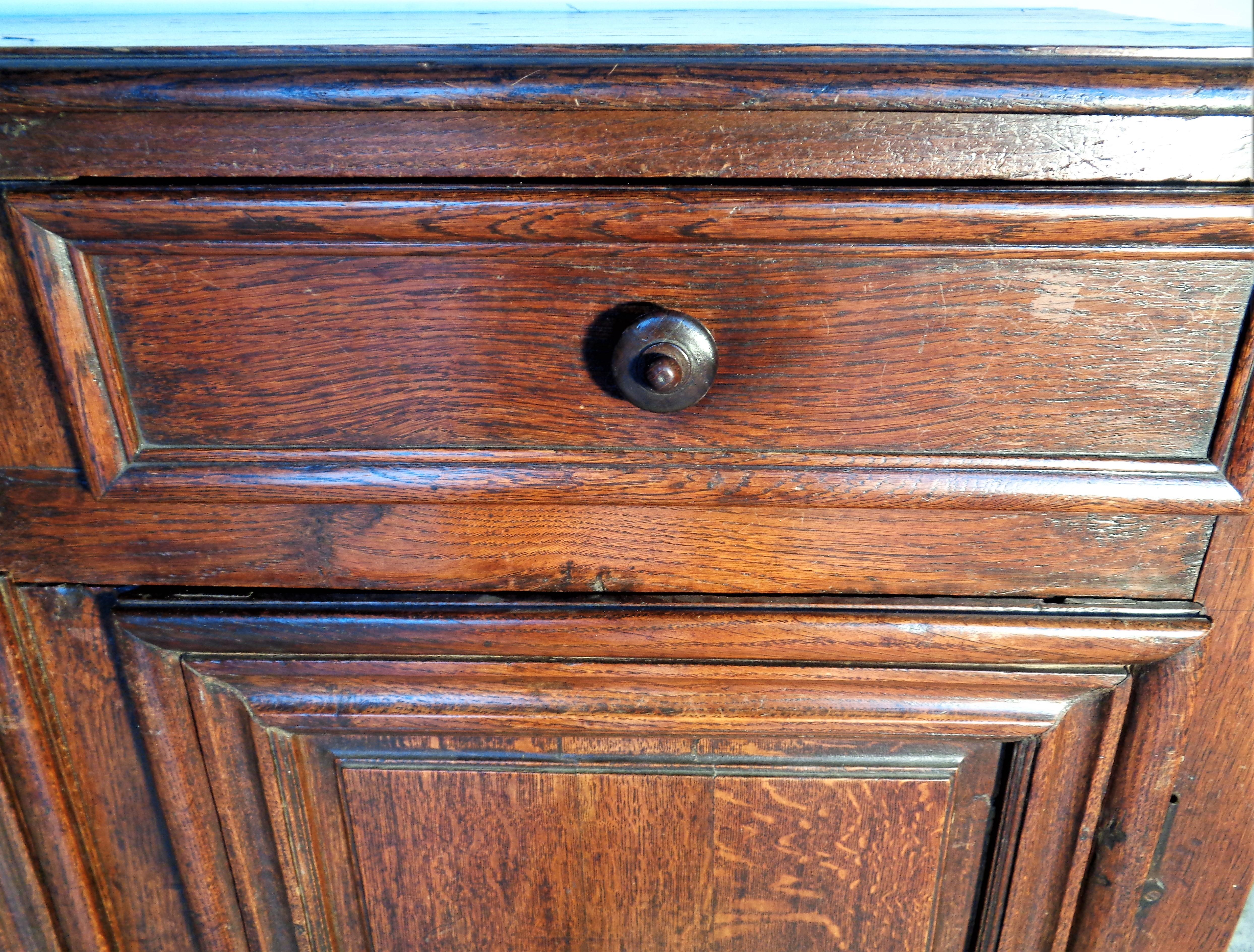 18th century French oak buffet sideboard server in beautifully aged original rich old surface color. Two deep upper drawers over two lower doors with early brass hardware and locking mechanism. Large open lower interior compartment with early single