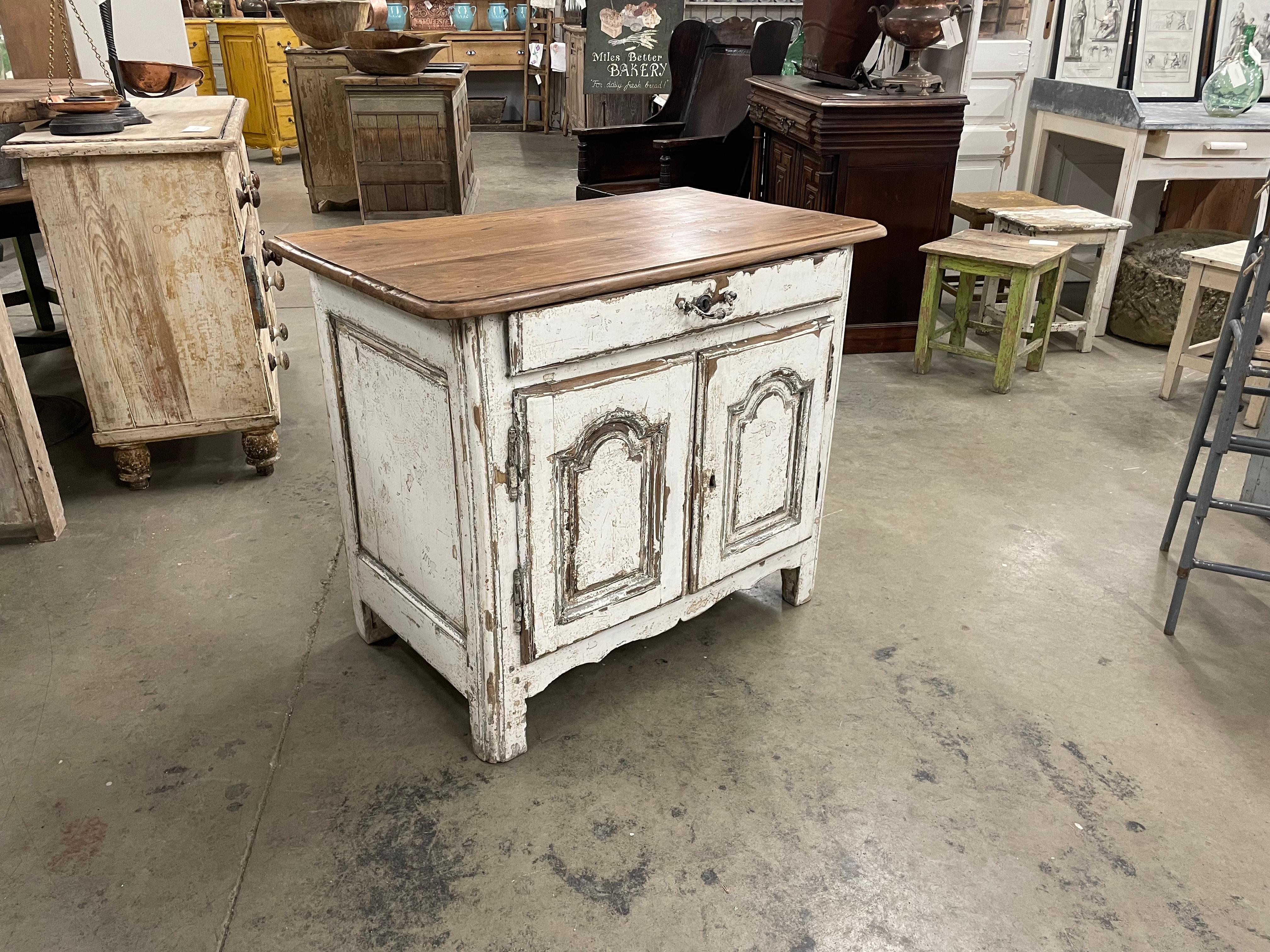 Antique French Provincial chunky oak cabinet or commode with its beautiful old hardware. It is dovetailed and peg jointed. The doors have deep recessed panels held in place with their original hinges. The cabinet has simple stile legs with a simply