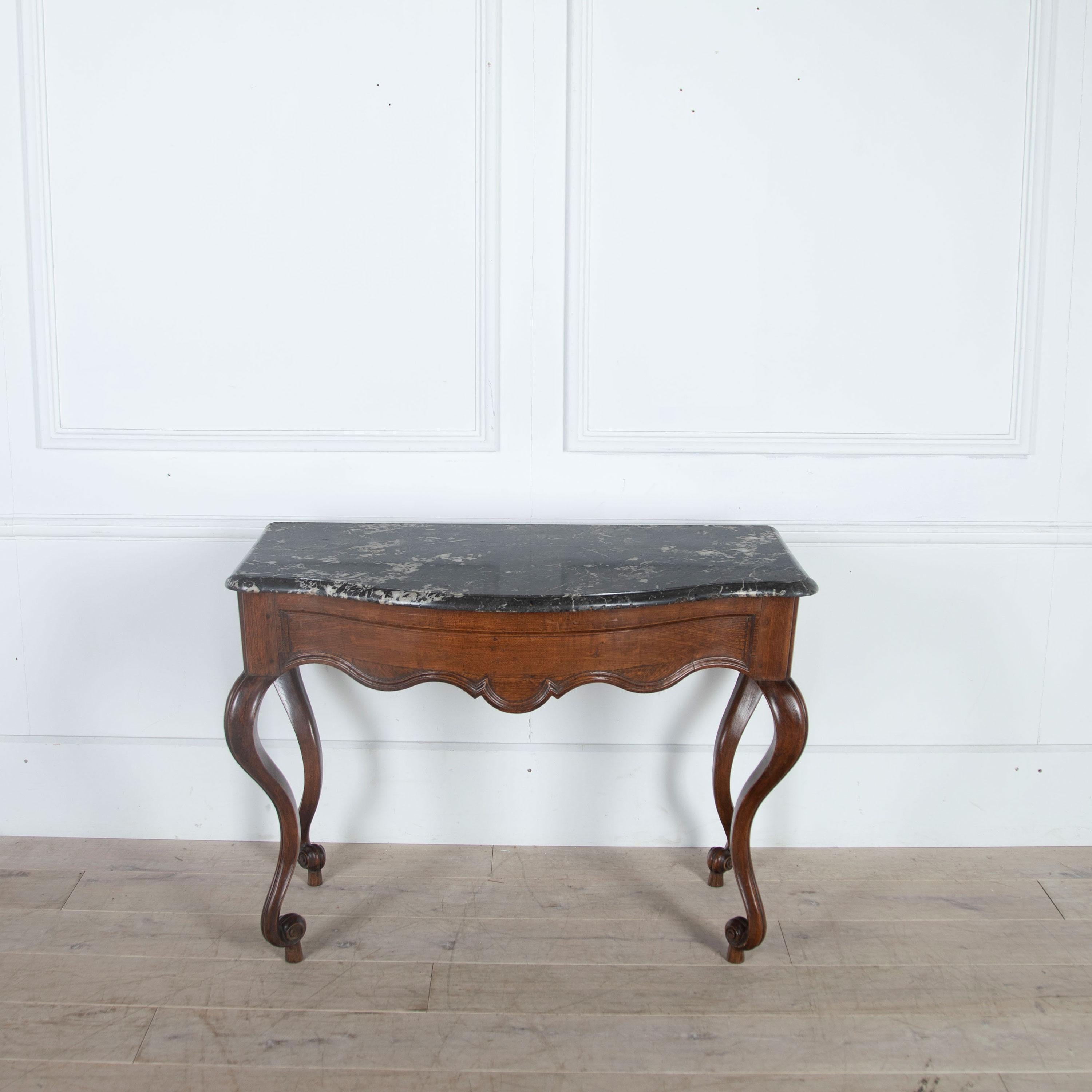 A wonderful shapely French oak console in original condition, retaining its original marble.
