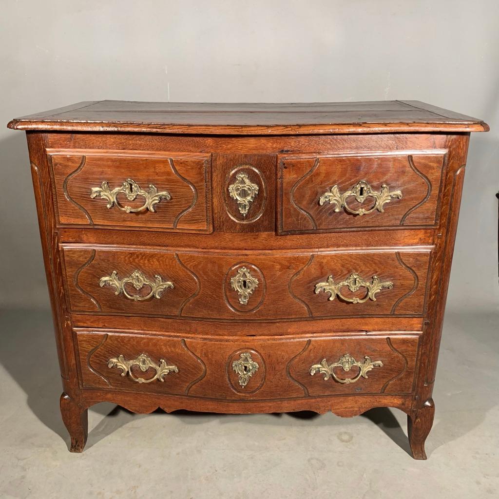 Really lovely and quite unusual French 18th century oak serpentine commode with all original brass handles and escutcheons.
The size is what I find so charming about this piece, as typically, you will find them considerably larger and a bit more