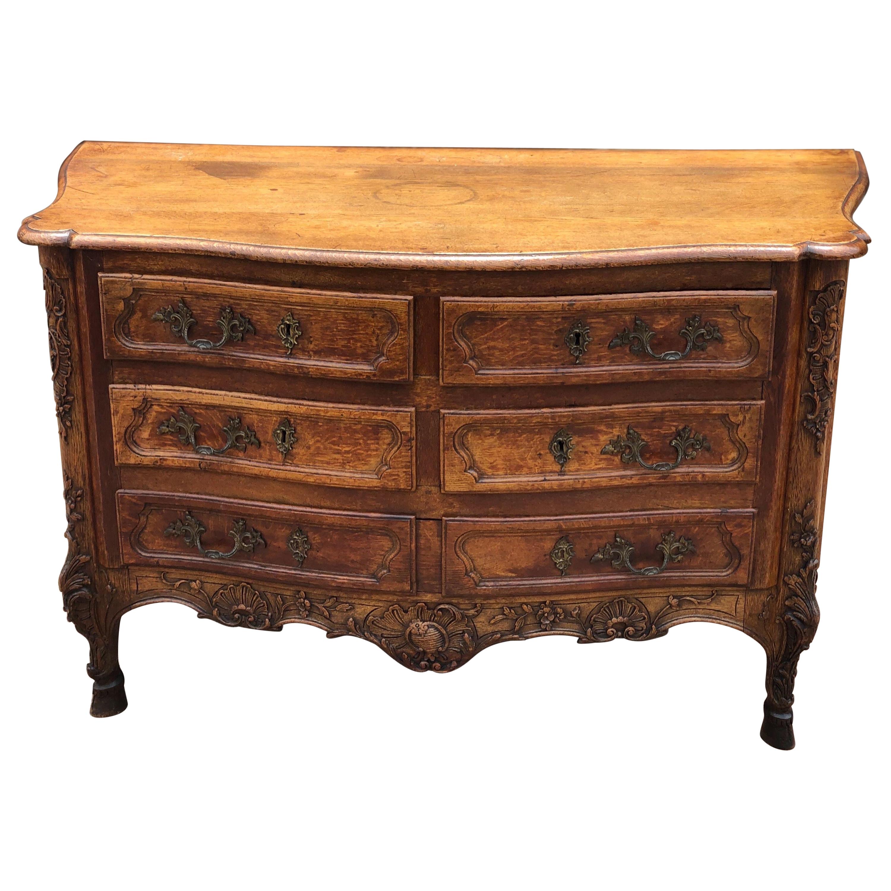 18th Century French Carved Oak Serpentine Commode on Hoof Feet For Sale