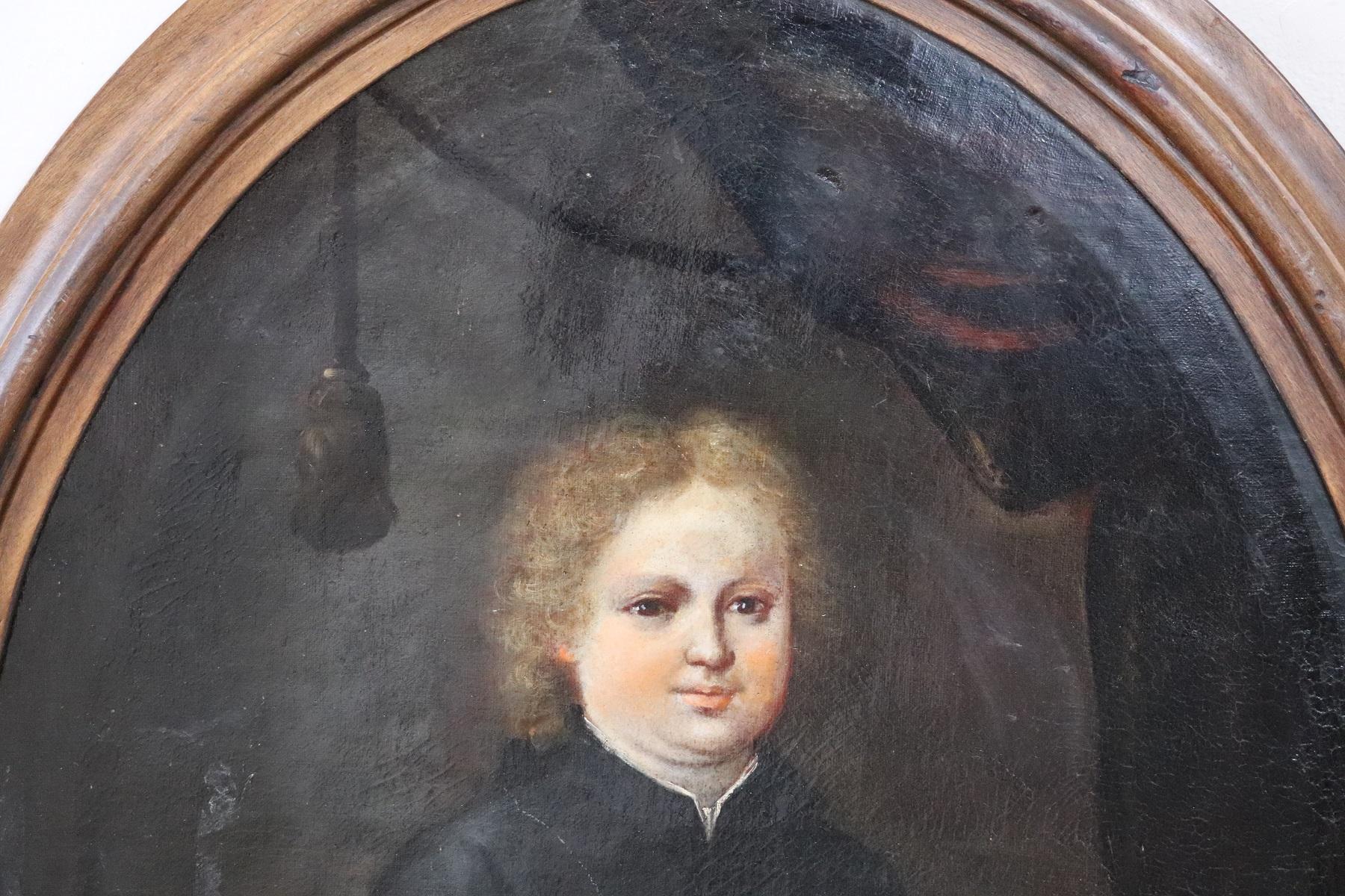 Important antique oil painting on canvas 18th century. The subject is a portrait of a child dressed in adult clothing certainly coming from a noble family. The child is holding a book that emphasizes its culture. On the back you can see a curtain.