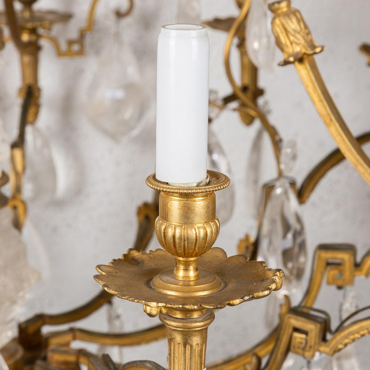 Antique late 18th Century French Impressive ormolu bronze and rock crystal chandelier. Each natural rock crystal crystal has been hand cut into pear shaped droplets with small flowers above and with a spherical faceted crystal ball underhanging. The