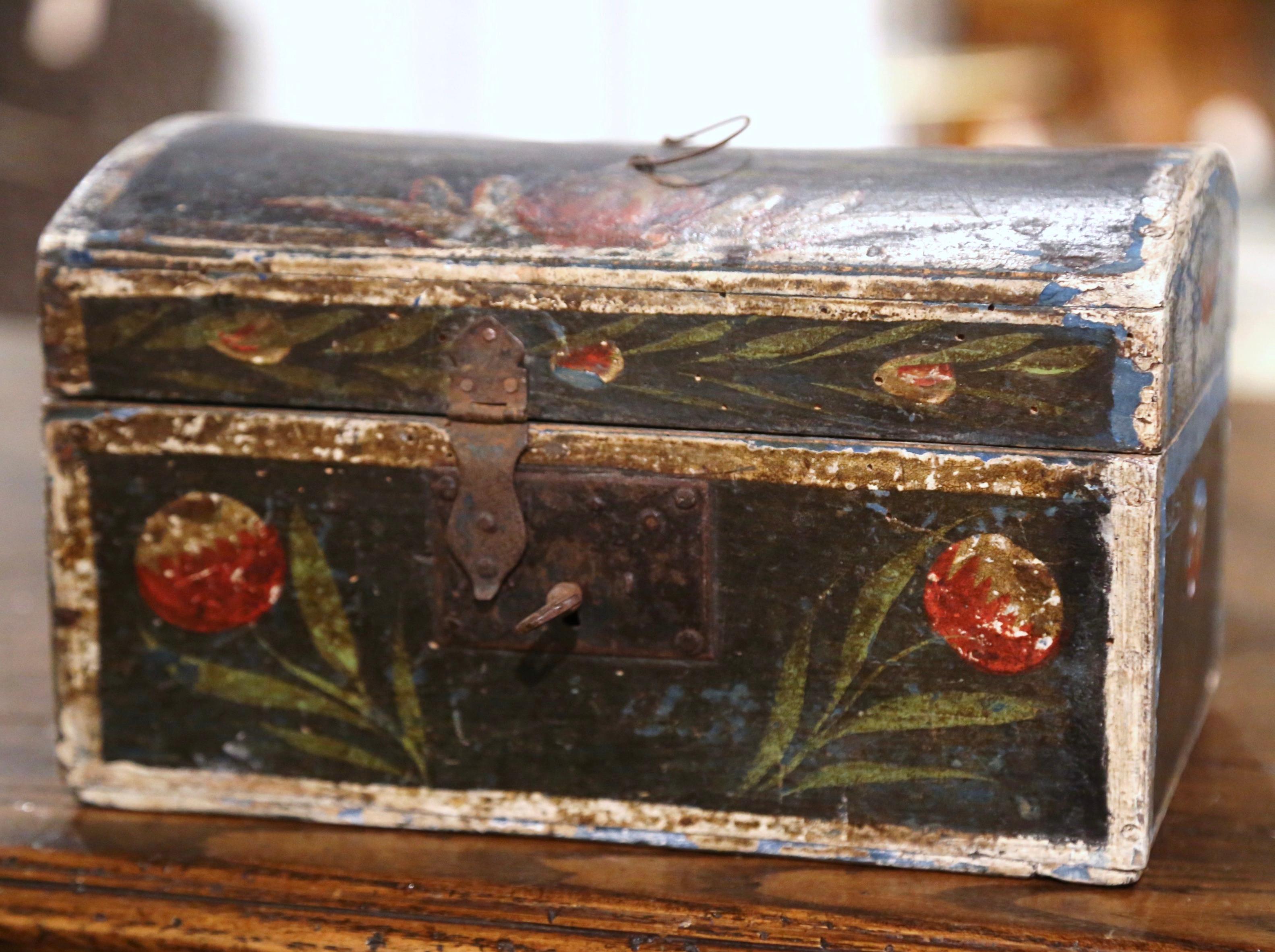 This beautifully executed antique wedding trunk was crafted in Normandy France, circa 1780. The colorful, arched box is decorated with multiple hand painted flowers and leaves scattered on all four sides including on the bombe top; the small box