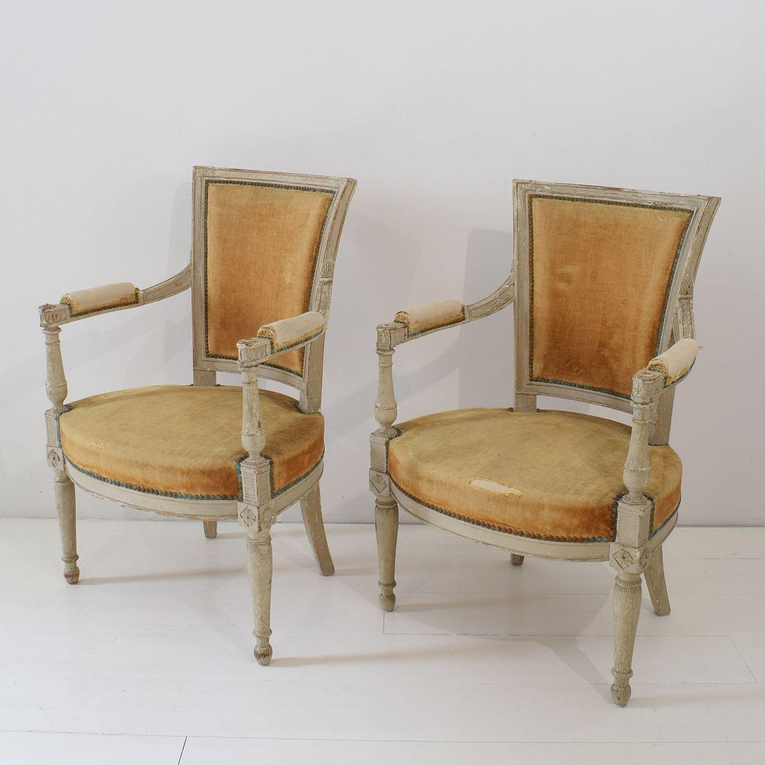 Beautiful pair of Directoire chairs, France, late 18th century. At this moment still upholstered with yellow velvet that needs to be replaced. Seat height is 42 cm. Weathered, small losses and old repairs. Despite of their high age, the chairs are