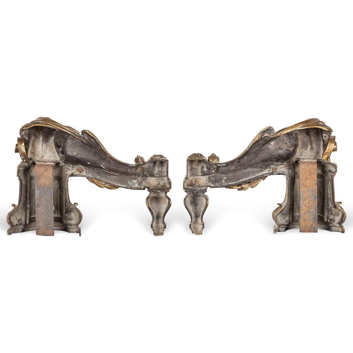 Antique mid 18th century French beautifully cast pair of gilt bronze fireplace chenets. These chenets are adorned with laurel garlands suspended over scrolls and grecian pillers, terminating with cross-key junctions and on shaped